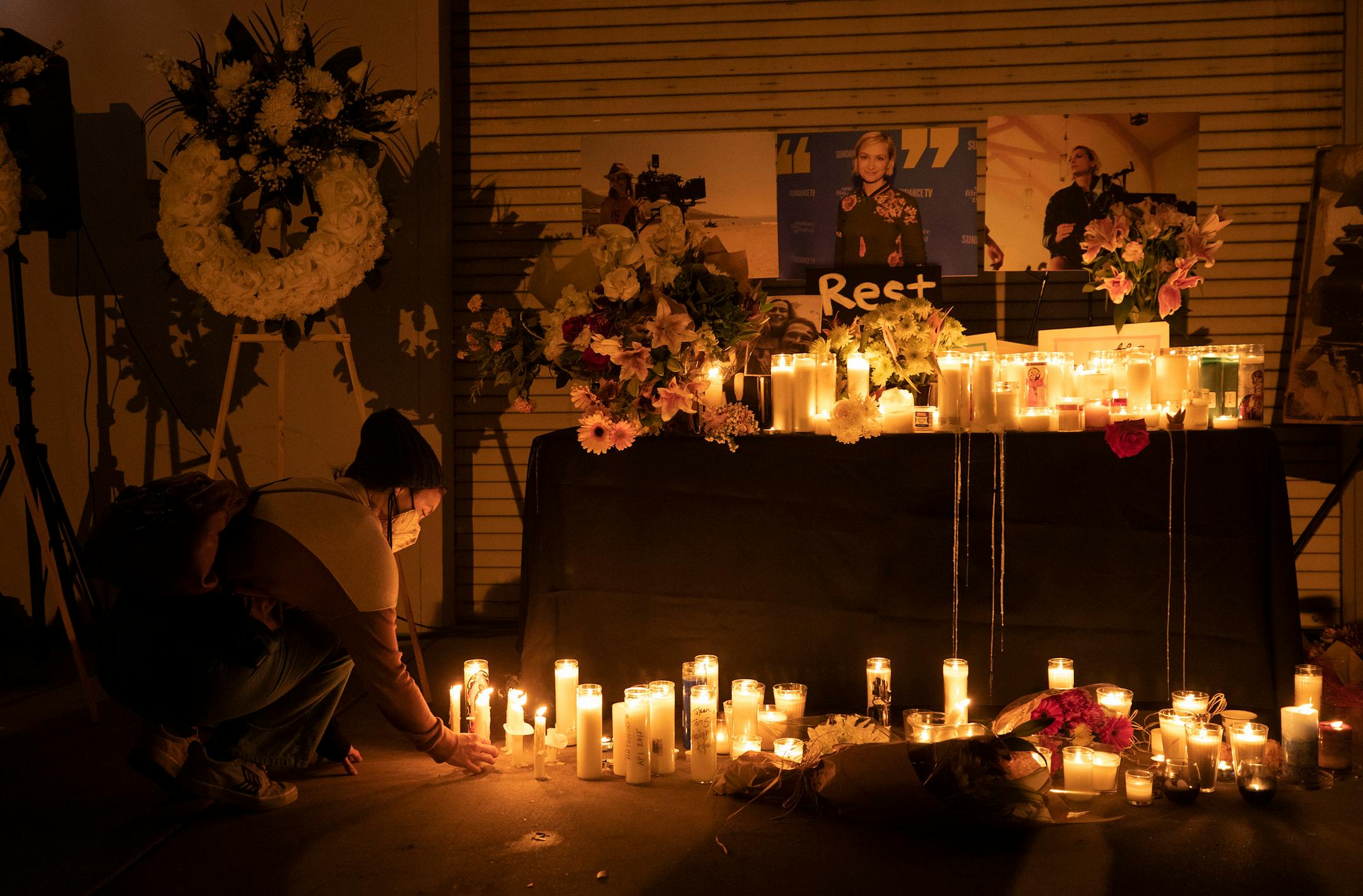 Jamie Frazer, who works in costumes and is a member of IATSE Local 705, places a candle during a vigil on Sunday, Oct. 24, 2021, at IATSE Local 80 in Burbank, California, for cinematographer Halyna Hutchins, who was fatally shot accidentally by Alec Baldwin on the "Rust" movie set at Bonanza Creek Ranch outside Santa Fe, New Mexico, on Thursday, Oct. 21, 2021. The movie's director Joel Souza also was injured in the accident. (Myung J. Chun/Los Angeles Times/TNS) ORG XMIT: 30575581W