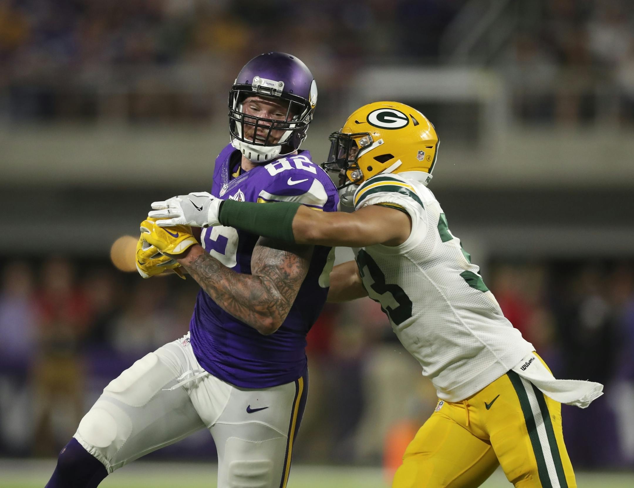 Vikings tight end Kyle Rudolph (82) was caught by Green Bay Packers strong safety Micah Hyde (33) after catching a pass for a four yard gain in the second quarter.
