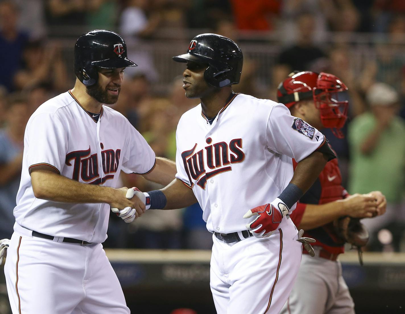 Twins first baseman Joe Mauer congratulated teammate Twins right fielder Torii Hunter after his three run homer in the first inning Thursday night at Target Field. ] JEFF WHEELER • jeff.wheeler@startribune.com The Twins faced the Los Angeles Angels in an MLB baseball game Thursday night, September 17, 2015 at Target Field in Minneapolis.