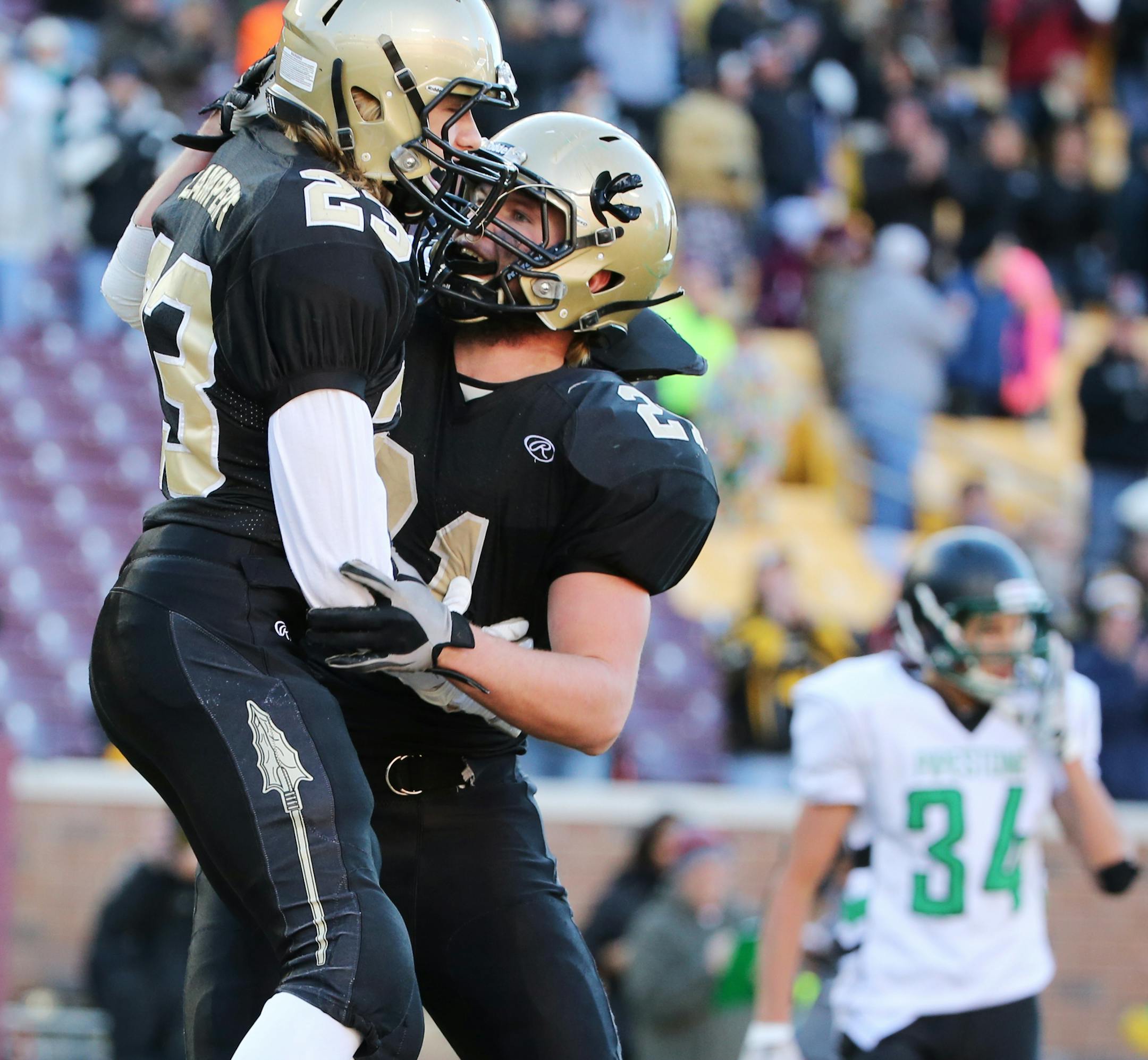 Caledonia's Colton Lampert, left, celebrates his touchdown with Alex Goergen in the first half. ] (Leila Navidi/Star Tribune) leila.navidi@startribune.com Caledonia plays against Pipestone in the class 2A state championship at TCF Bank Stadium in Minneapolis on November 13, 2015.