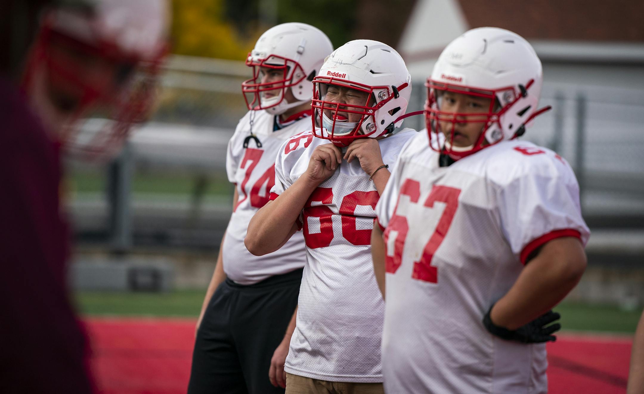 North St. Paul football player Charlie Vu adjusted his mask during practice.