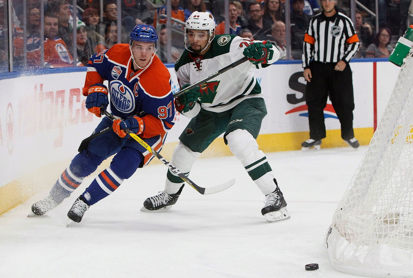 Minnesota Wild's Matt Dumba (24) defends against Edmonton Oilers' Connor McDavid (97) during the second period of an NHL hockey game in Edmonton, Alberta, Sunday, Dec. 4, 2016. (Jason Franson/The Canadian Press via AP)