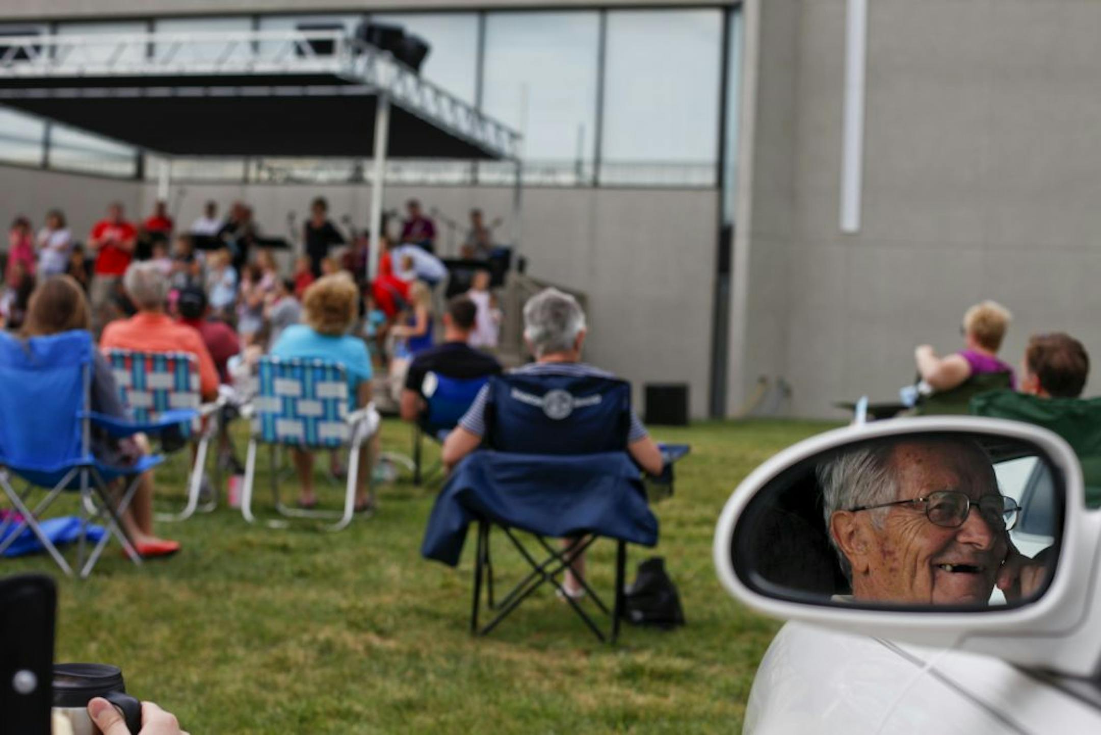 Al Jaeger sits in the comfort of his car as he listens to the outdoor service of the Prince of Peace Lutheran Church The church has offered outdoor summer services for 40 years. in Burnsville. The church has offered outdoor summer services for 40 years.