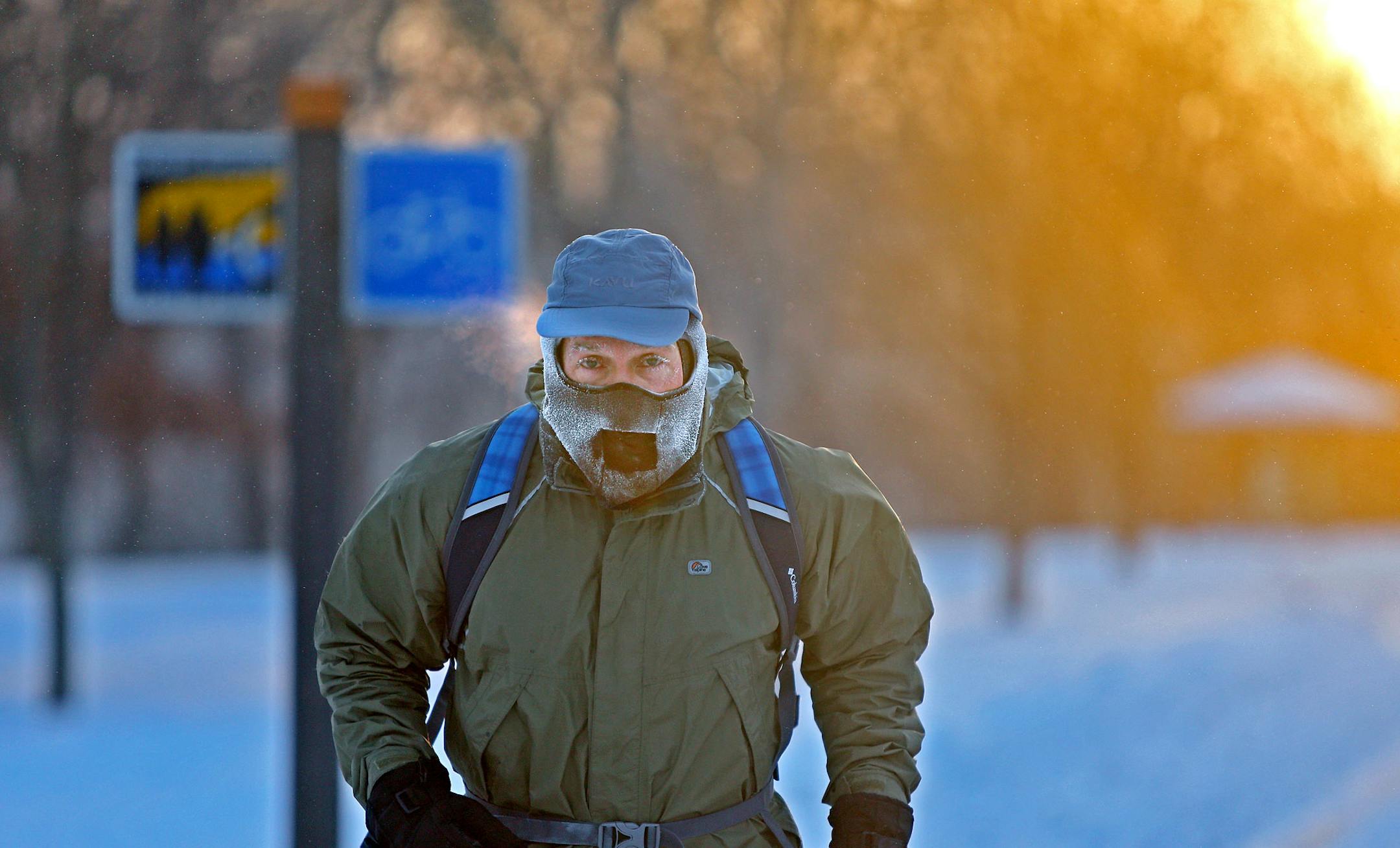 John Brower braves the frigid -20 weather to run to work at sunrise along West River Parkway, Monday, Jan. 6, 2014, in Minneapolis. (AP Photo/The Star Tribune, Elizabeth Flores) MANDATORY CREDIT; ST. PAUL PIONEER PRESS OUT; MAGS OUT; TWIN CITIES TV OUT