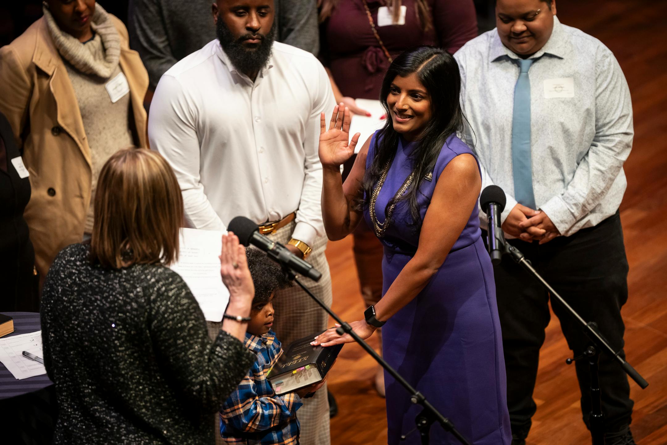 New Council Member Saura Jost's, Ward 3, son (I don't have his name) held the book she rested her hand on as she was sworn in at the swearing in ceremony of the seven female St. Paul city council members, four new to the council, at the Ordway Center on Tuesday, Jan. 9, 2024 in St. Paul, Minn. ] RENEE JONES SCHNEIDER • renee.jones@startribune.com