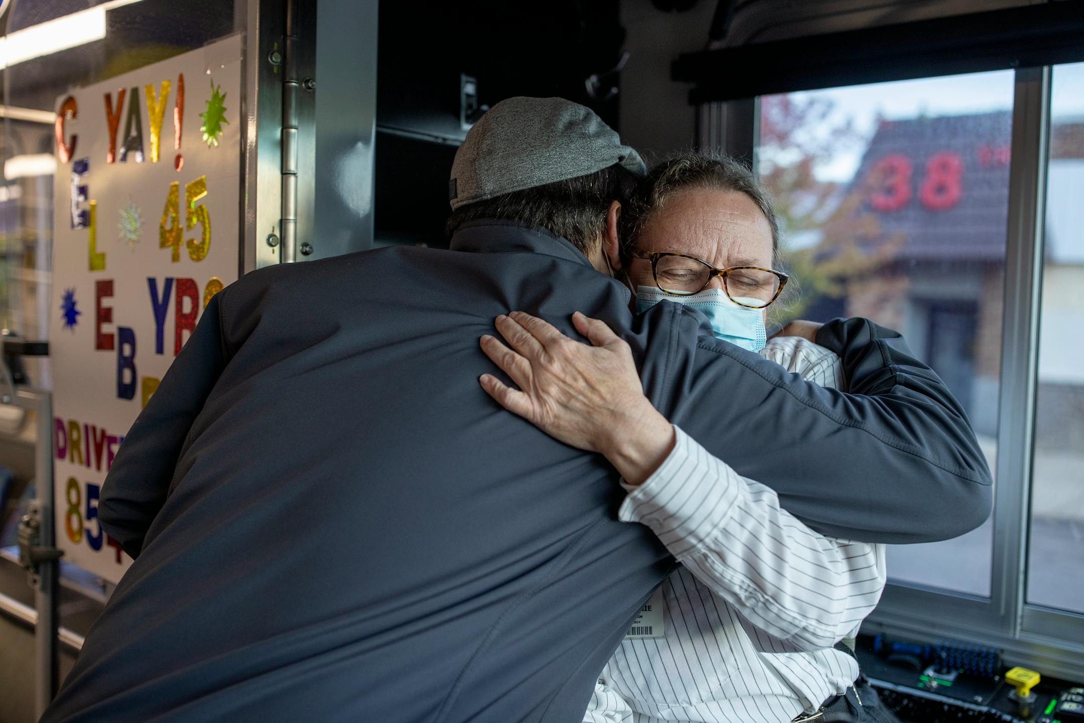 Melanie Benson hugged a passenger as he got off her bus Monday, October 11, 2021 between Minneapolis and St. Paul.