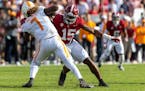 Alabama edge rusher Dallas Turner (15) pursues Tennessee quarterback Joe Milton III during a game last October. Turner recently starred at the NFL sco