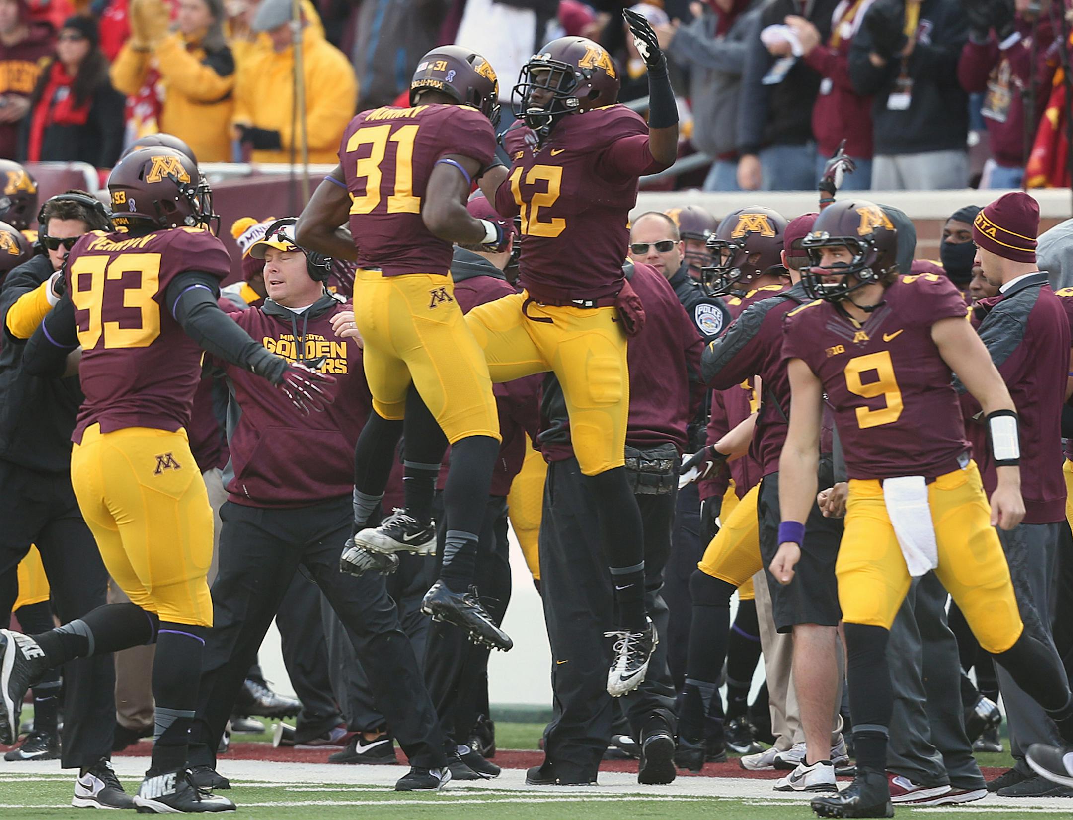 The Gophers, including Eric Murray (31) and Steven Montgomery (12), celebrated late in the fourth quarter.