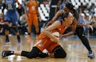 Phoenix Mercury's guard Diana Taurasi calls out to the ref while fighting for possession of the ball against Minnesota Lynx's guard Jia Perkins during