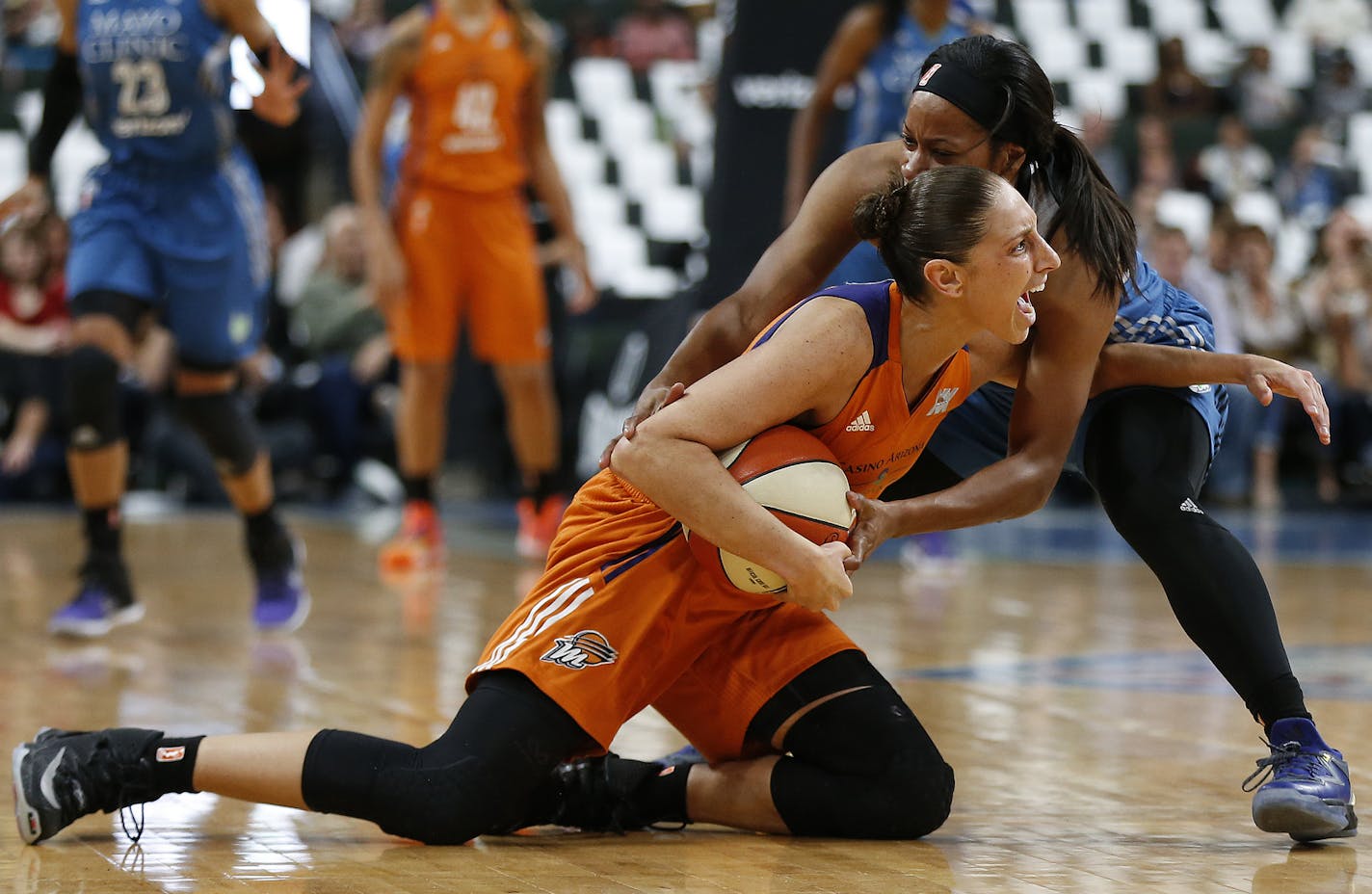 Phoenix Mercury's guard Diana Taurasi calls out to the ref while fighting for possession of the ball against Minnesota Lynx's guard Jia Perkins during the first half of Game 2 of the WNBA basketball semifinals, Friday, Sept. 30, 2016, in St. Paul. The Lynx won 96-86. (AP Photo/Stacy Bengs)