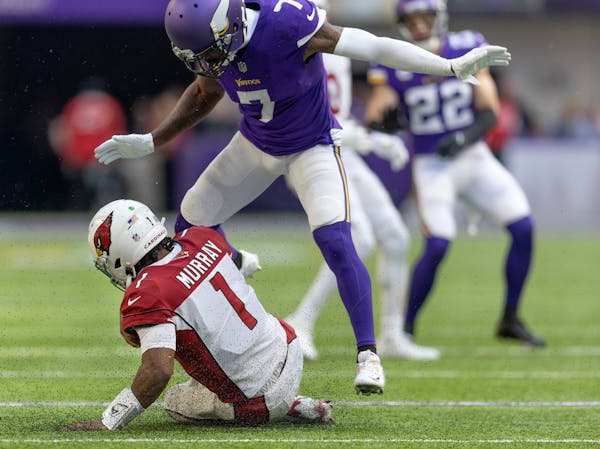 Cardinals quarterback Kyler Murray (1) slid under Vikings cornerback Patrick Peterson (7) during the third quarter.