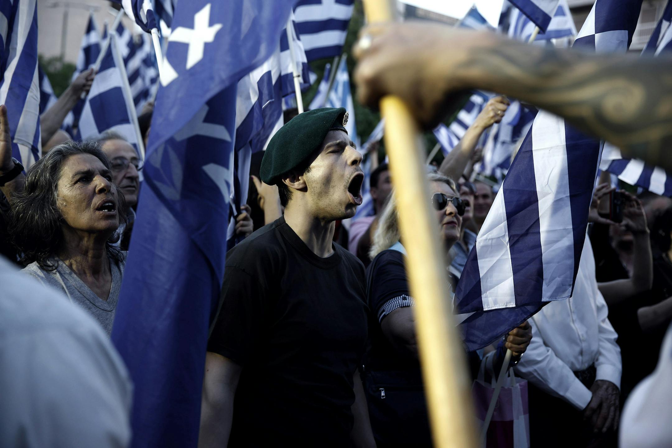 Supporters shout slogans and wave Greek flags during the main election rally of the extreme right party Golden Dawn on Friday, May 23, 2014. New polls published Friday indicated that the Nazi-inspired party, which rose out of Greece's political margins two years ago, is likely to come in third in Sunday's European Parliamentary elections, with around 8 percent of the vote nationwide. Golden Dawn's leader and his deputy have been behind bars since last fall and have been followed recently by seve