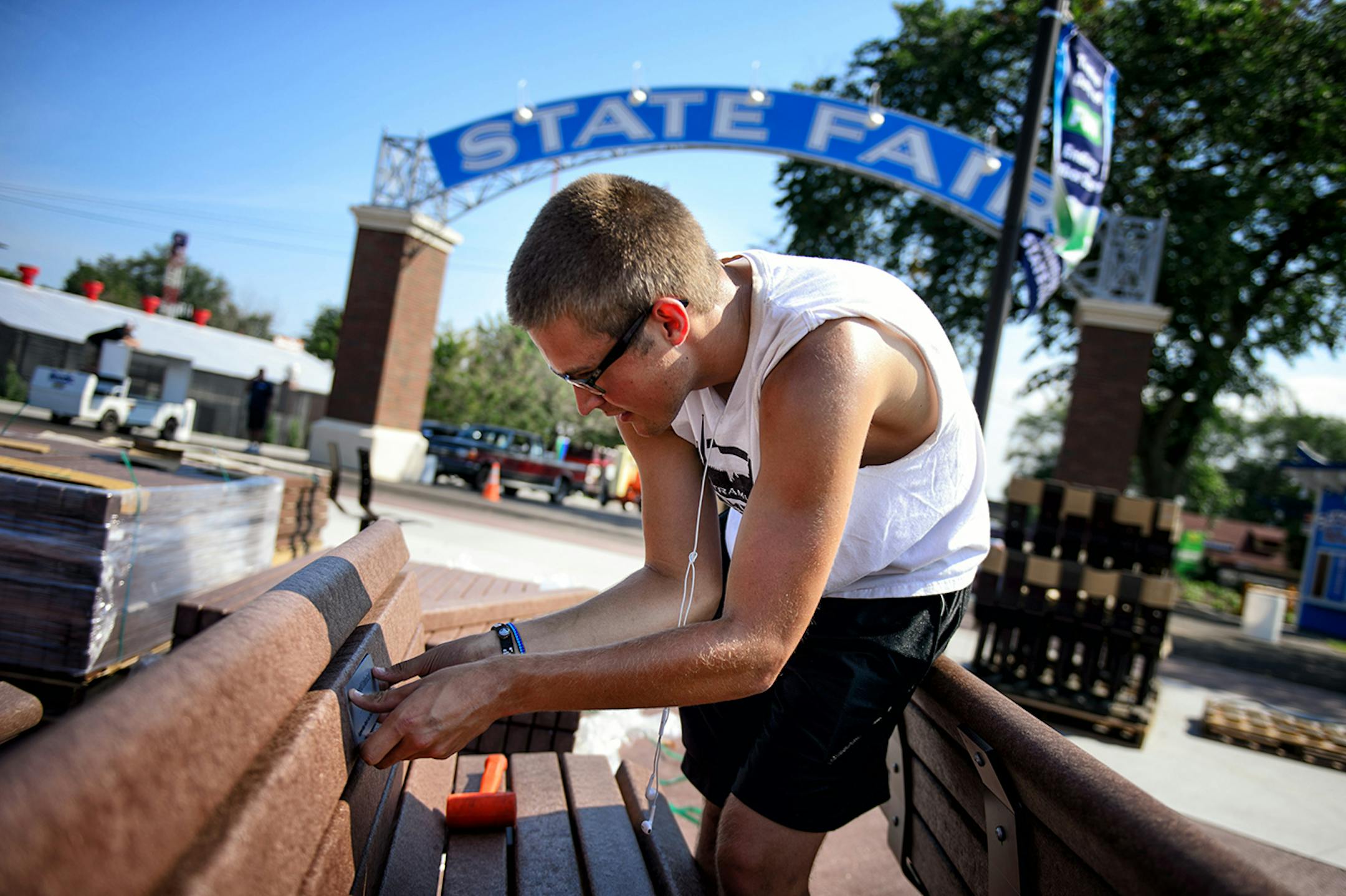 Lars Erickson inserted donor plaques into around 100 new State Fair Foundation benches for the new West End Market. The opening of the 2014 Minnesota State Fair is less than a week away and the place is hopping. ] Thursday, August 14, 2014. GLEN STUBBE * gstubbe@startribune.com