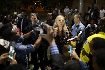 A woman who refused to identify herself, explained results to caucus goers after a vote was taken to determine delegates supporting either Abdi Warsam