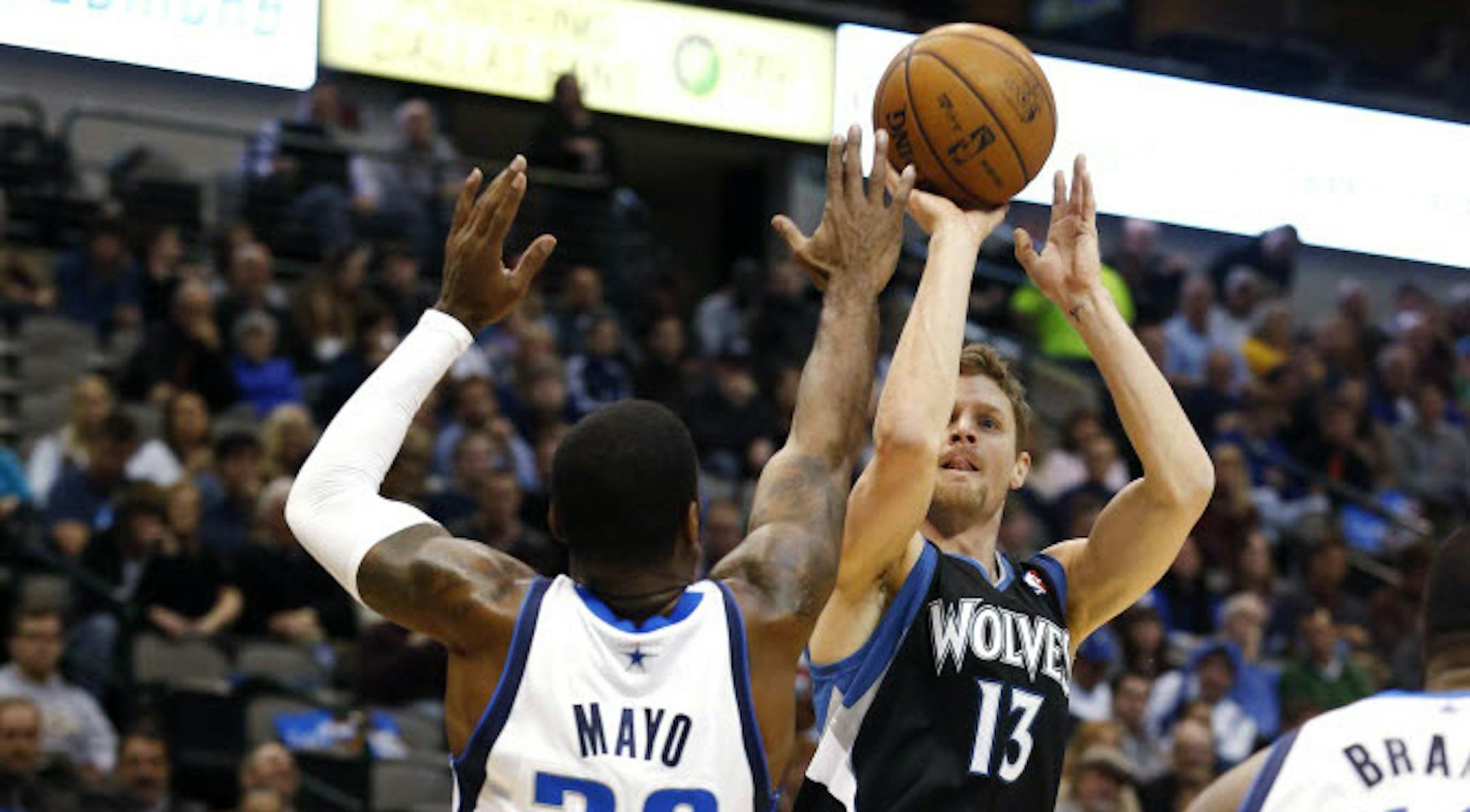 The Wolves' Luke Ridnour (13) shot over Dallas' O.J. Mayo during the Mavericks' 113-98 victory Monday night.