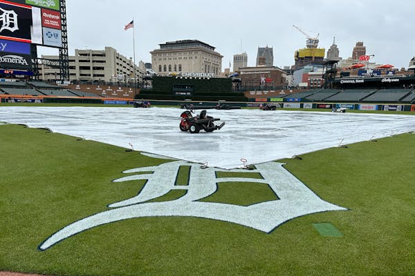 A tarp covers the Comerica Park field before a baseball game between the Detroit Tigers and the New York Mets, Tuesday, May 2, 2023, in Detroit. (AP P