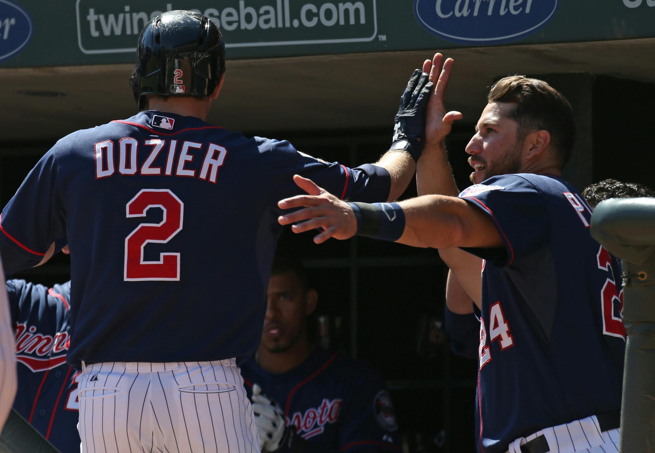 (left to right) Minnesota Twins Brian Dozier celebrated with Trevor Plouffe after hitting a first inning home run.