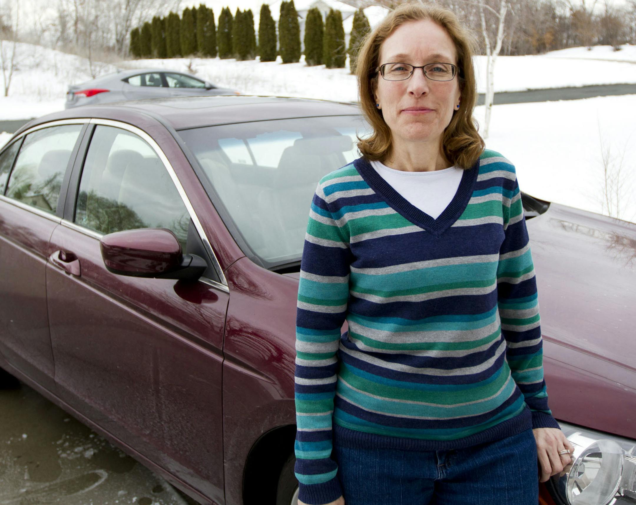 Lynn Jancik posed for a portrait next to her 2009 Honda Accord that was damaged by a pothole on I-94 and Huron two years ago. Jancik was one of five motorists whose car was significantly damaged by the single pothole. ] NICOLA LOSIK* nicola.losik@startribune.com