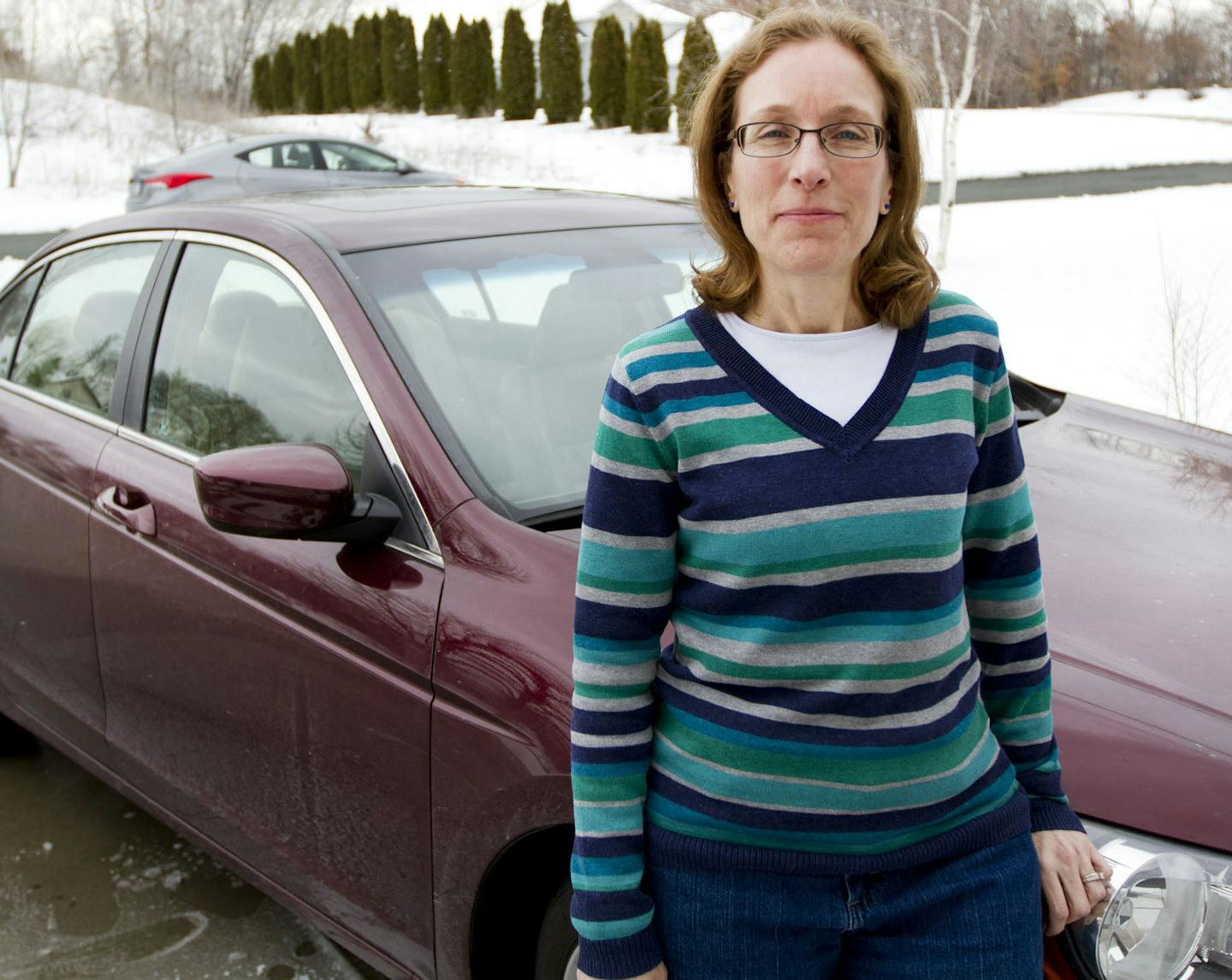 Lynn Jancik posed for a portrait next to her 2009 Honda Accord that was damaged by a pothole on I-94 and Huron two years ago. Jancik was one of five motorists whose car was significantly damaged by the single pothole. ] NICOLA LOSIK* nicola.losik@startribune.com