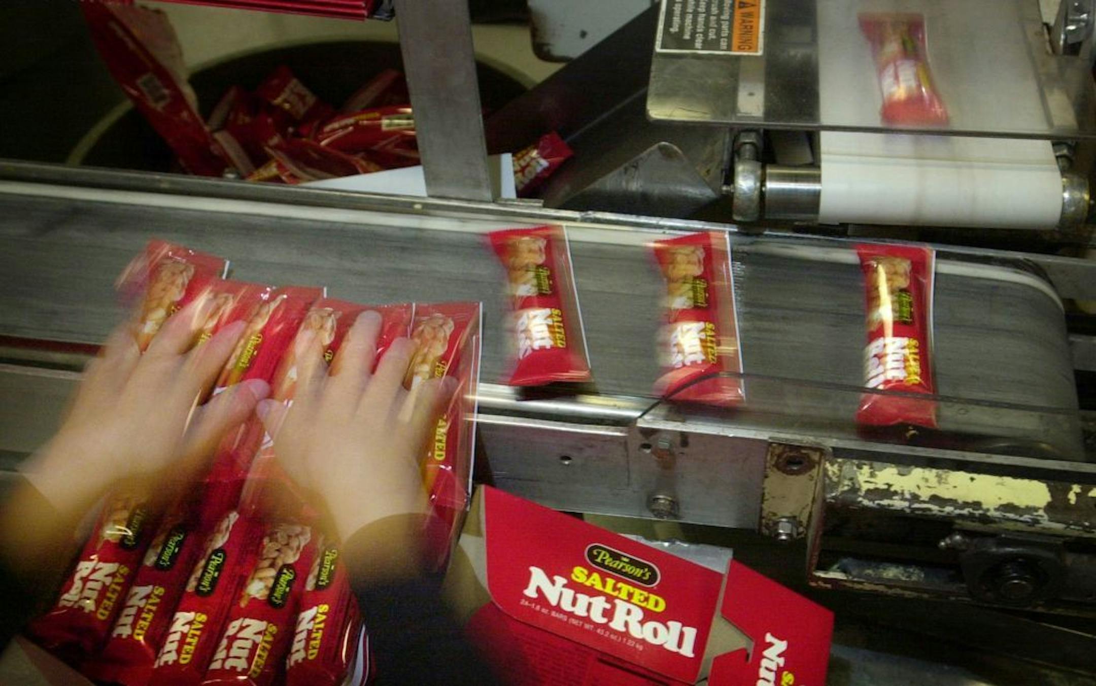 A worker boxed Pearson's Salted Nut Rolls by hand in 2003.