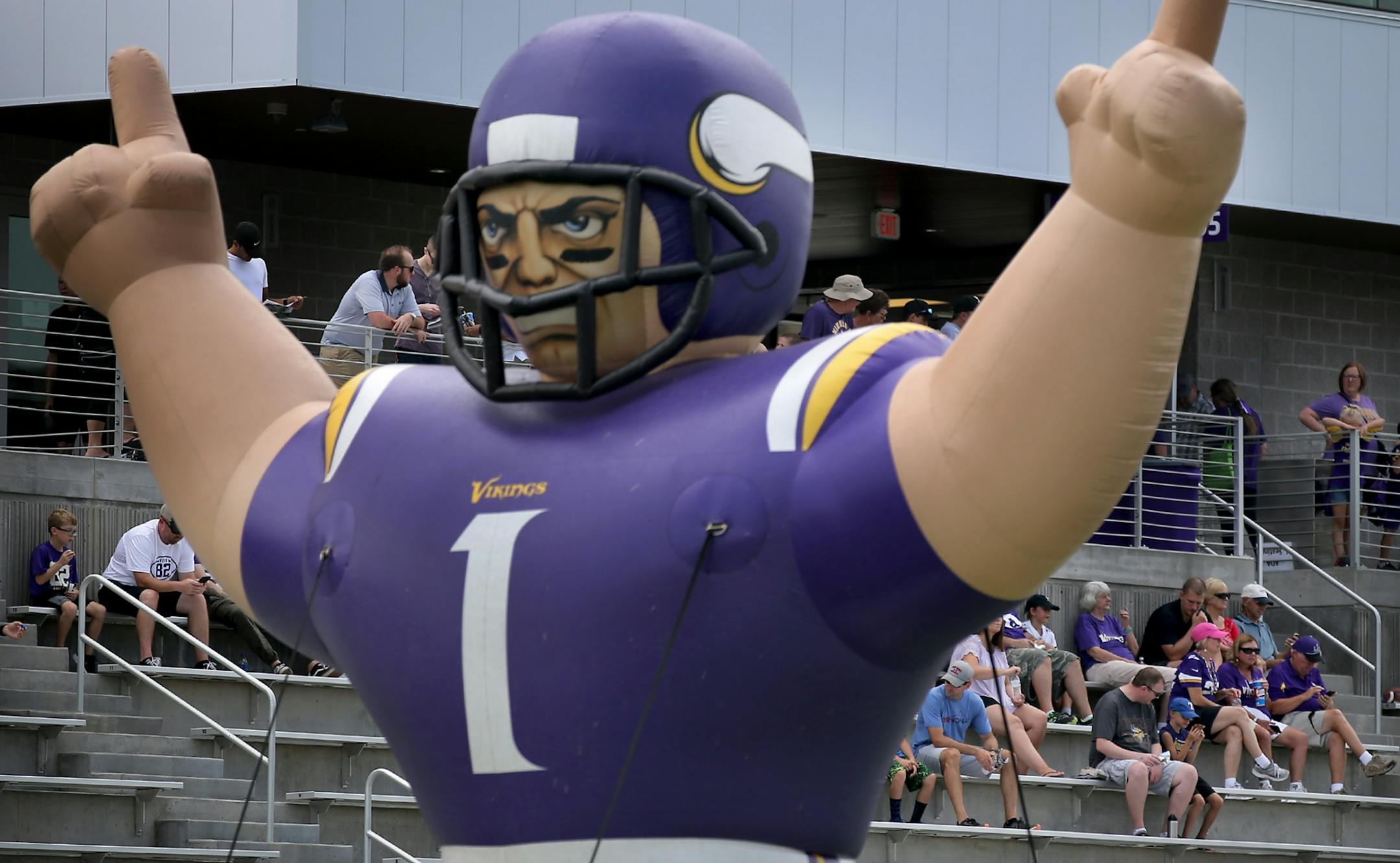Before a joint practice between the Minnesota Vikings and the Jacksonville Jaguars, fans sit in the stands by a giant inflatable Viking Thursday, Aug. 16, 2018, TCO Performance Center in Eagan, MN.