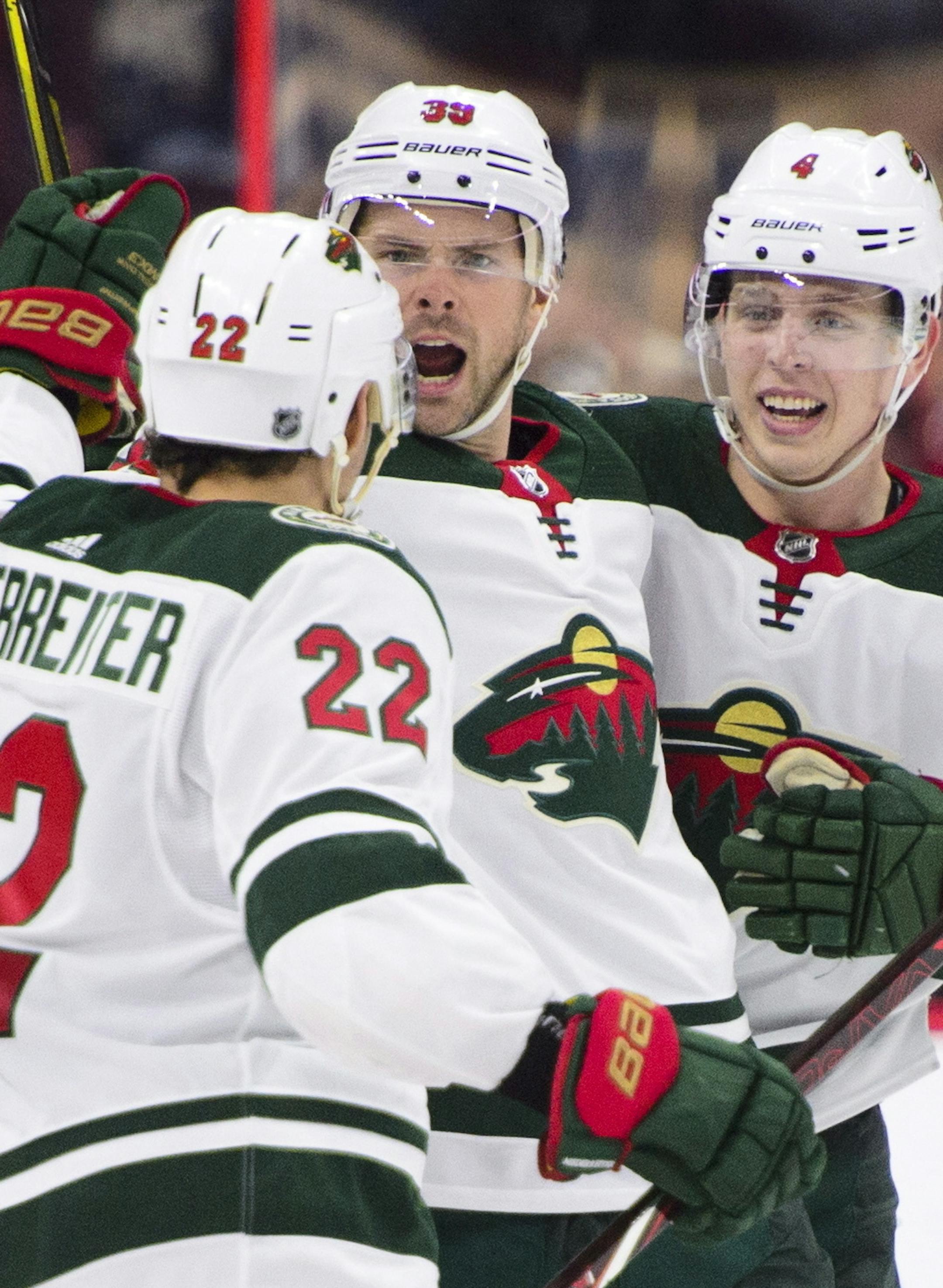 Minnesota Wild's Nino Niederreiter, left to right, Nate Prosser and Mike Reilly celebrate a goal against the Ottawa Senators during third period NHL hockey action in Ottawa on Tuesday, Dec. 19, 2017. (Sean Kilpatrick/The Canadian Press via AP)