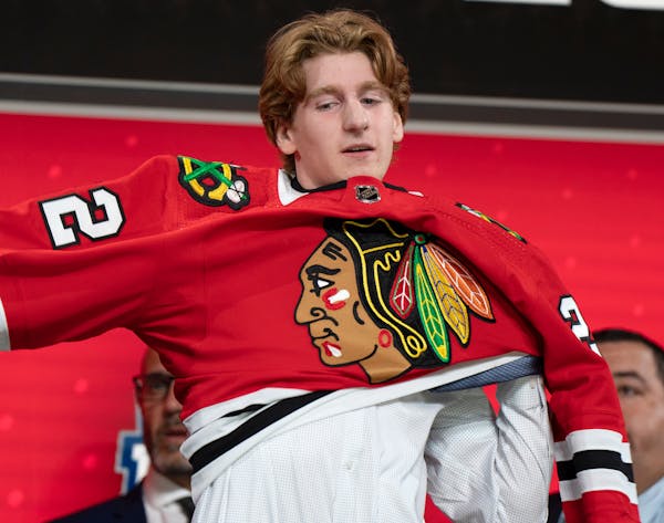 Sam Rinzel pulled on the Blackhawks jersey after Chicago took him 25th overall at the NHL draft Thursday in Montreal.
