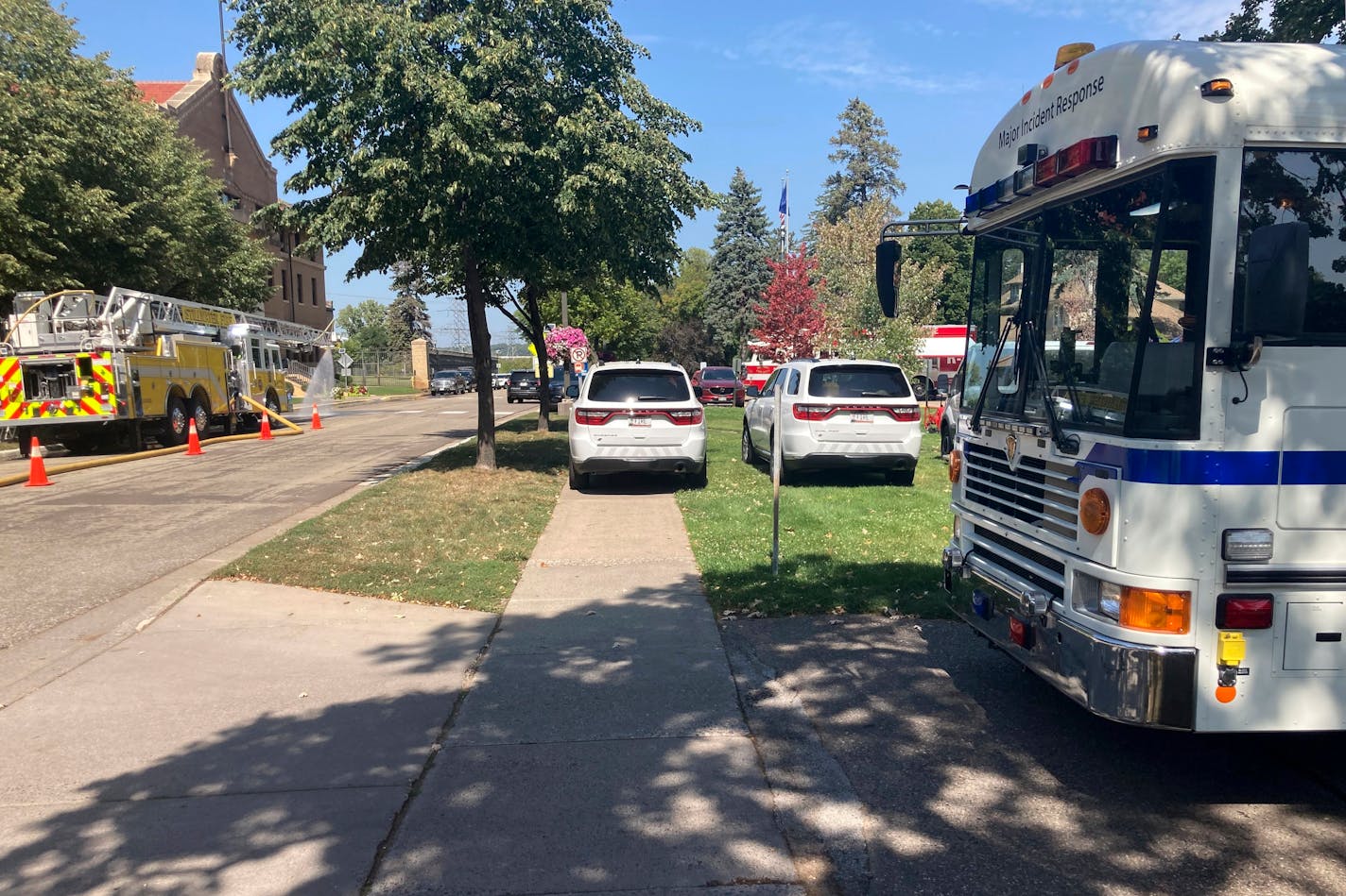 A fleet of emergency vehicles sit parked outside of Minnesota Correctional Facility-Stillwater prison in Bayport, Minn., on Sunday, Sept. 3, 2023. The prison was placed on emergency lockdown after about 100 inmates in a housing unit facing dangerously high heat would not return to their cells. (David Boehnke via AP)