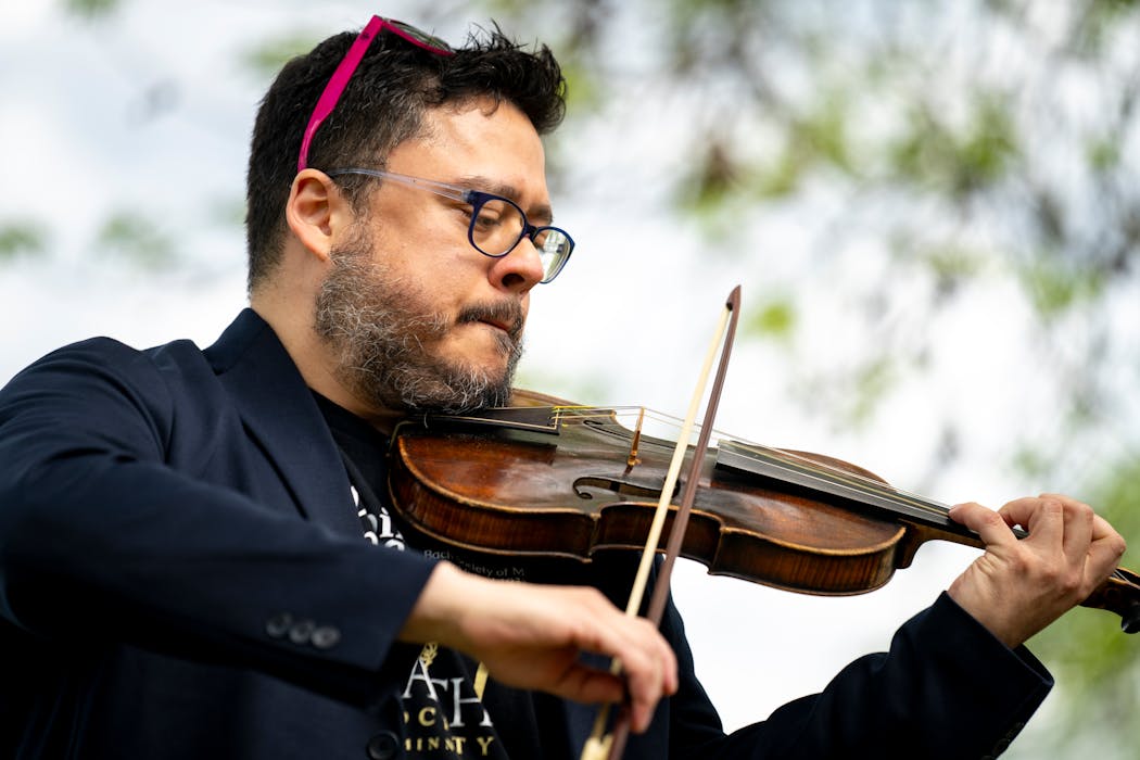 Marco Real-d'Arbelle performs a piece by Italian violinist Nicola Matteis at a pop-up concert at Rosebrook Park on Friday in Roseville. Real-d'Arbelle’s violin was set up to sound as a violin 300 years ago would sound like, making it authentic for the piece he was playing. Real-d’Arbelle is part of the Minnesota Back Society, who hosts the Minnesota Back Society’s Bach Festival which includes, among other things, these Mobile Mini Concerts where solo musicians are playing for intimate pop-up audiences.
