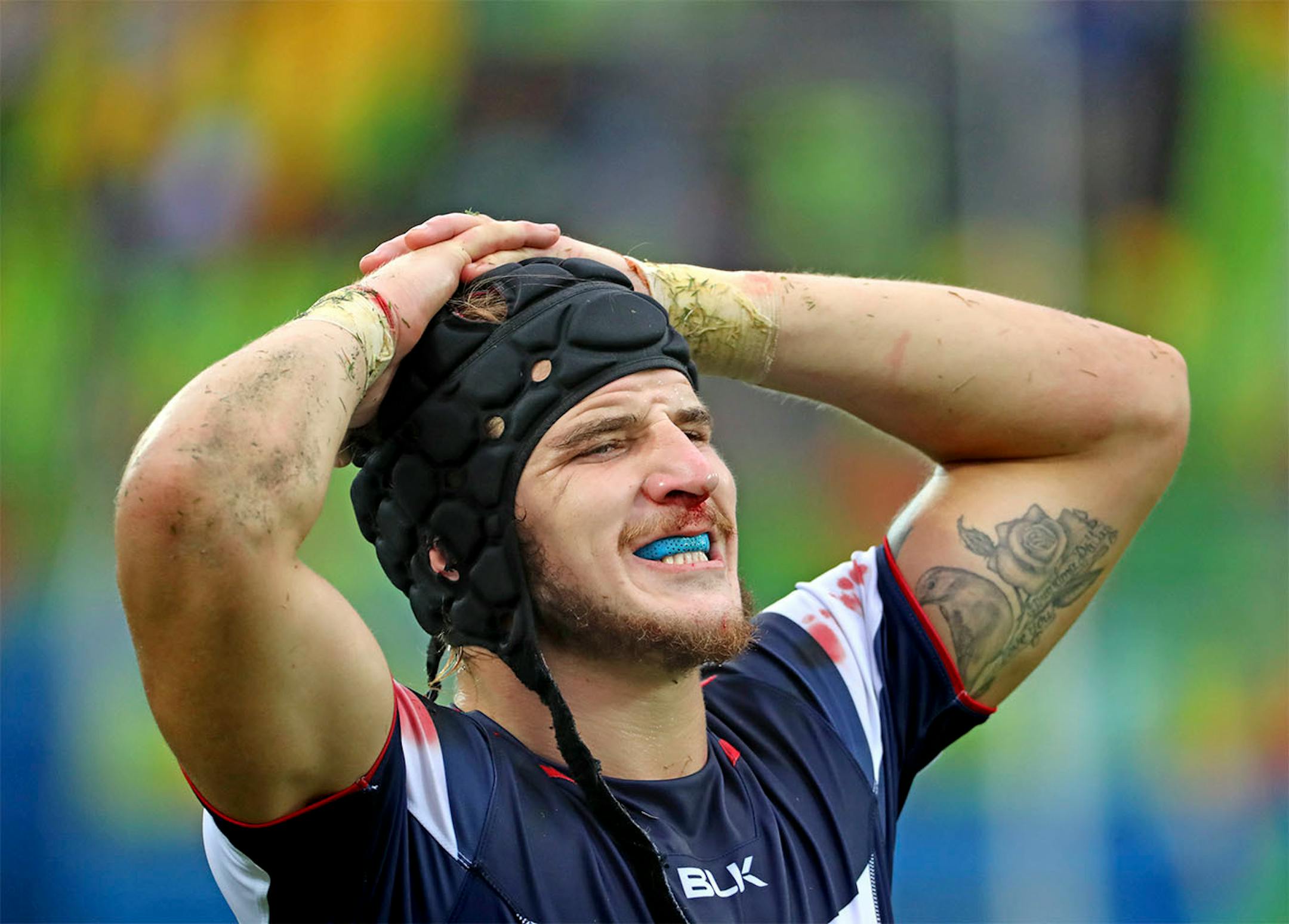 The United States men's rugby sevens team fell to Fiji 24-19 Wednesday afternoon at Deodoro Stadium to end preliminary play with a 1-2 record. Here, Garrett Bender was bloddied and grass stained after the match.