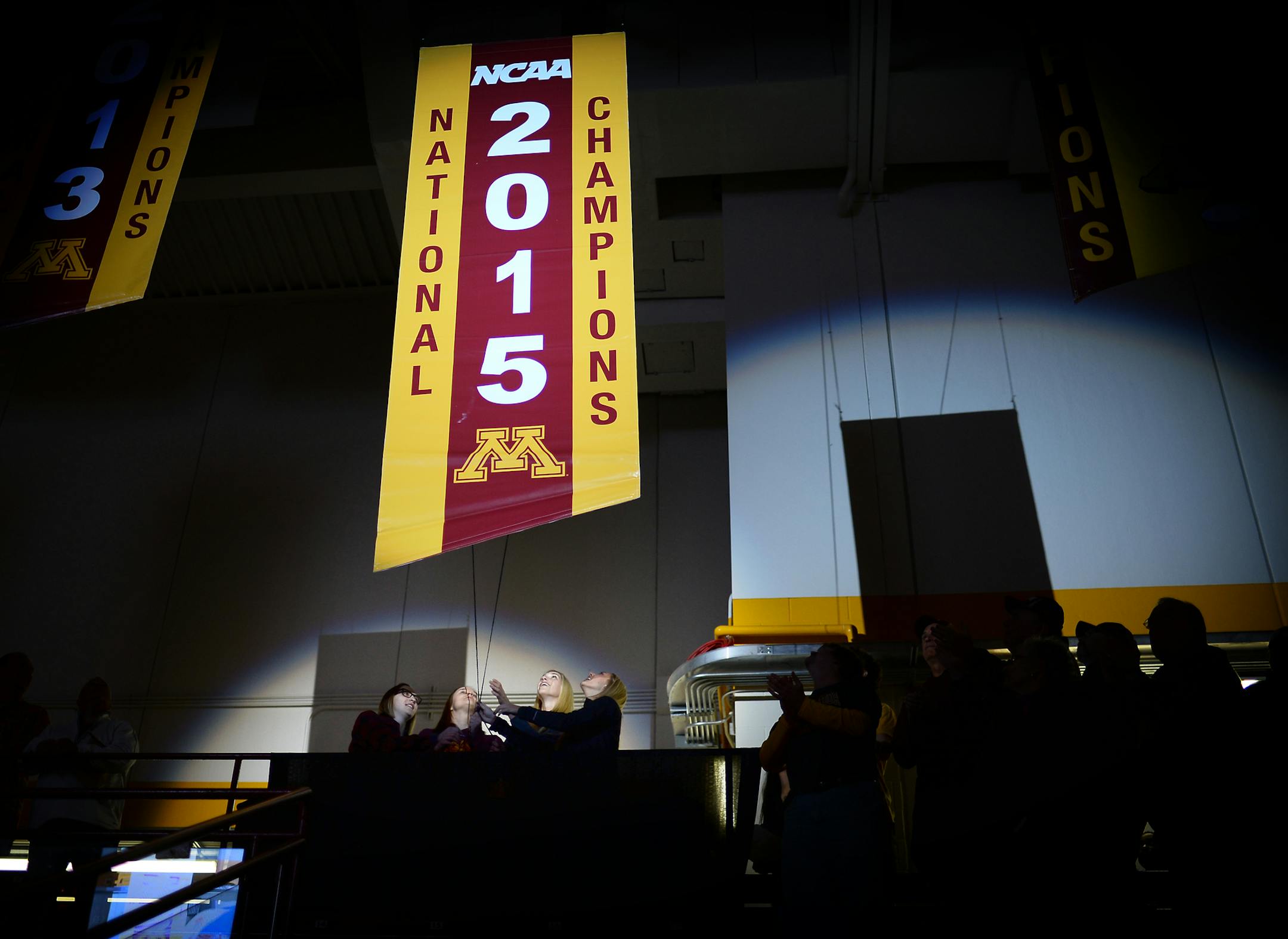 Members of the 2015 NCAA Champion Gophers hockey team including, from left, Shyler Sletta, Meghan Lorence, Rachael Bona and Rachel Ramsey raised their championship banner before Friday night's game against St. Cloud University. ] Aaron Lavinsky • aaron.lavinsky@startribune.com The University of Minnesota Golden Gophers women's hockey team played the St. Cloud State University Huskies on Friday, Oct. 9, 2015 at Ridder Arena.