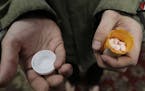 In this Nov. 14, 2019 photo, Jon Combes holds his bottle of buprenorphine, a medicine that prevents withdrawal sickness in people trying to stop using