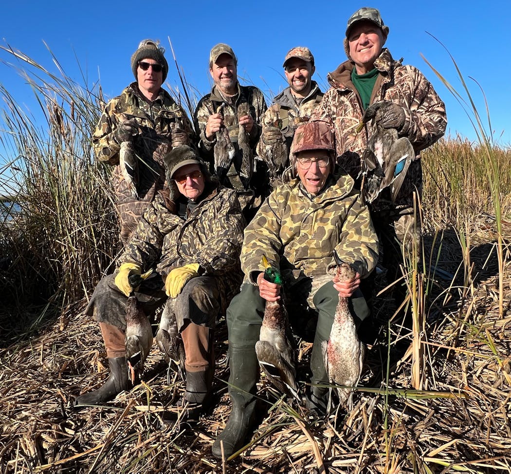 Brothers Henry Ernst, 98, (left, seated) and John Ernst, 96, of St. Paul have been hunting ducks together for about 85 years. In back, standing, are Henry’s son Brad Ernst, friends John Knoblauch and his son, Joe Knoblauch, and John Ernst’s son, Johnny Ernst.