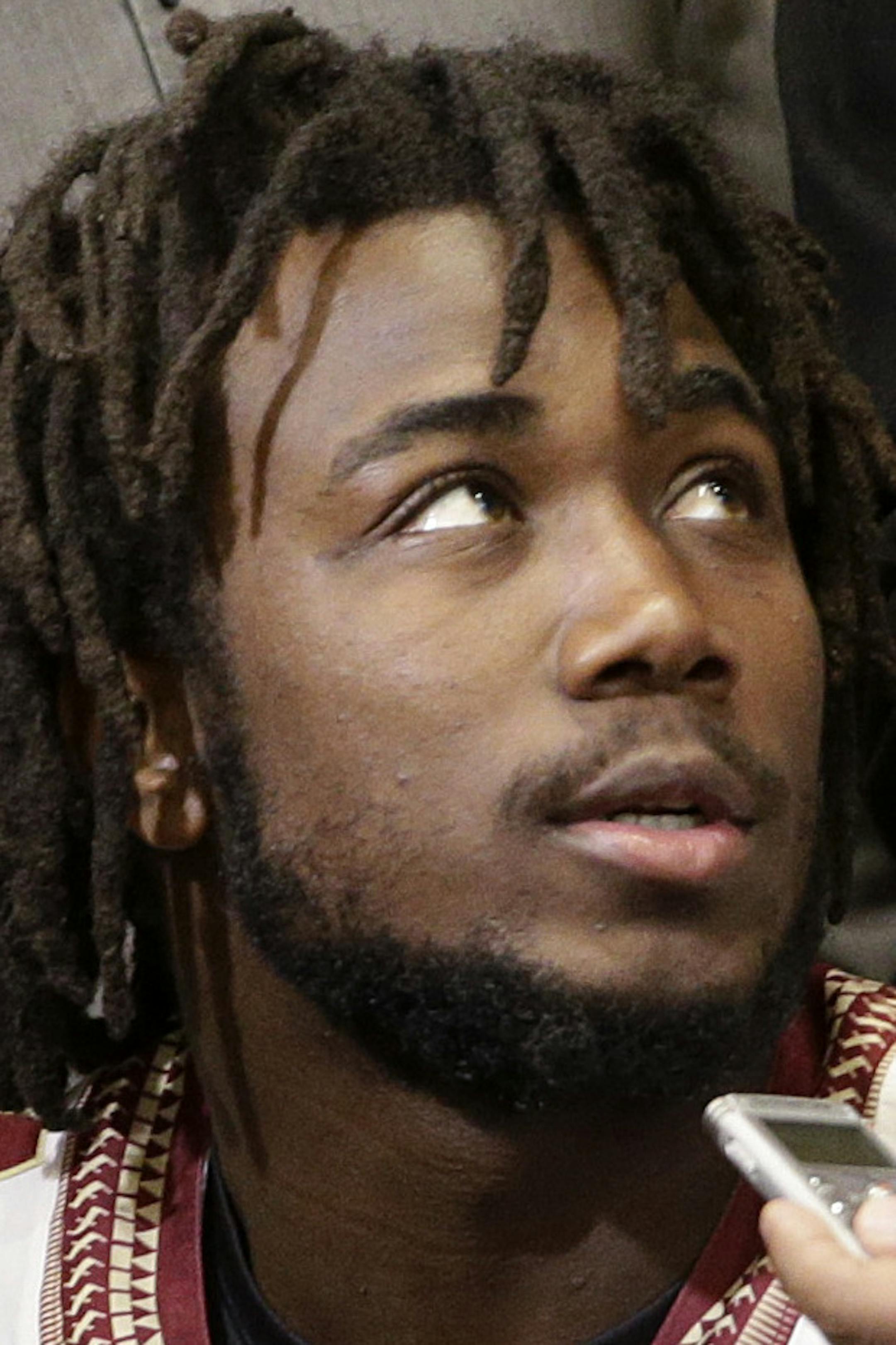 FILE - In this Dec. 29, 2014, file photo, Florida State running back Dalvin Cook, center, is surrounded by reporters during the team's media day, for the Rose Bawl, in Los Angeles. The trial for suspended Florida State running back Dalvin Cook on charges that he punched a woman in the face outside a downtown bar has begun. The incident happened in June, and Cook's lawyer requested a speedy trial. It began Monday morning, Aug. 24, 2015, and is expected to last a day. (AP Photo/Jae C. Hong, File)
