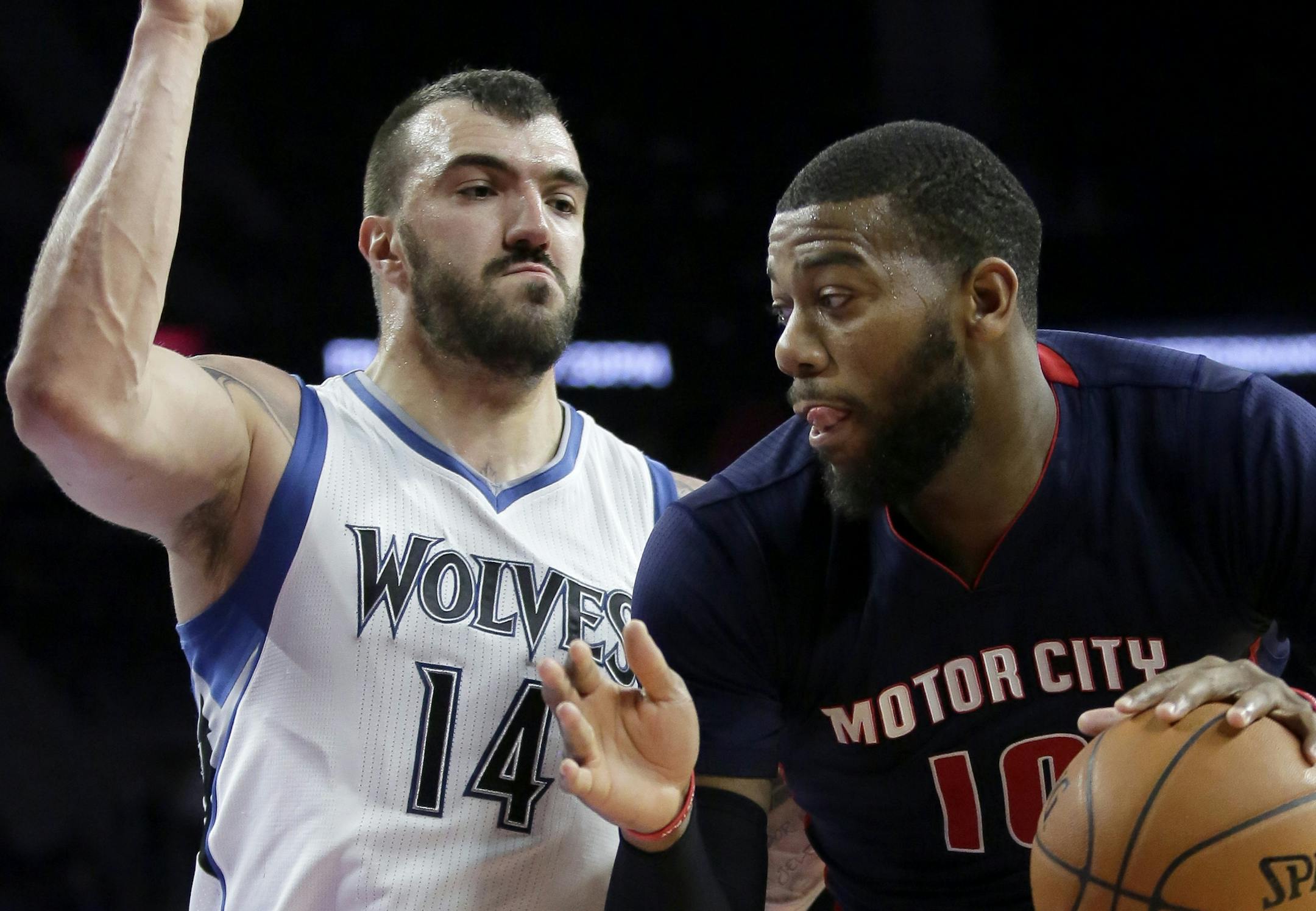 Detroit Pistons' Greg Monroe, right, drives to the basket against Minnesota Timberwolves' Nikola Pekovic (14) during the second half of an NBA basketball game Sunday, Feb. 8, 2015, in Auburn Hills, Mich.