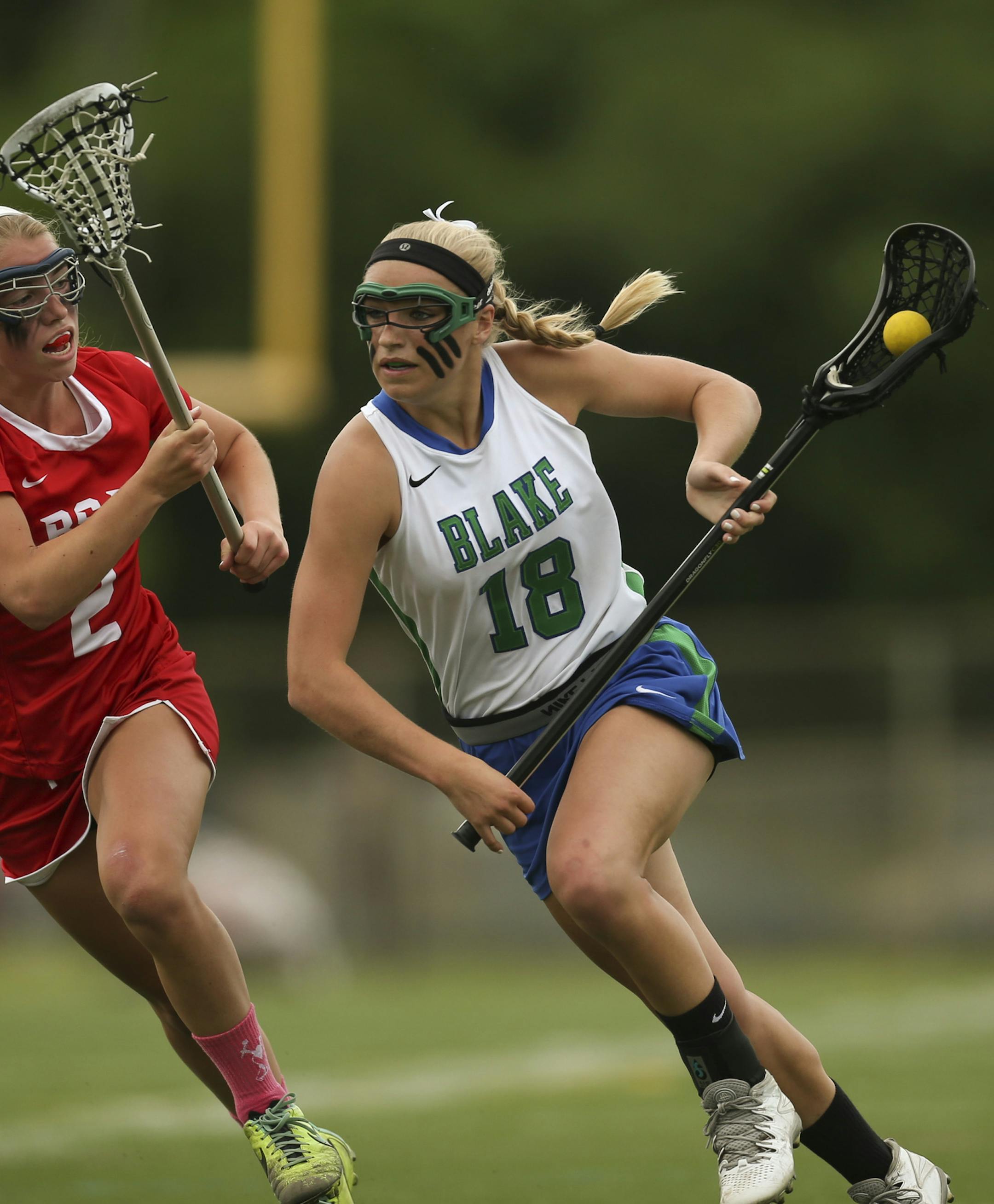 Lydia Sutton (18) of Blake charged around the defense of BSM's Emily Schmitz during their game Tuesday afternoon at BSM. ] JEFF WHEELER ‚Ä¢ jeff.wheeler@startribune.com Lydia Sutton of Blake repeats as the Star Tribune's all-metro girl's lacrosse Player of the Year. Blake beat Benilde - St. Margaret's for the Section 6 championship Tuesday afternoon, June 3, 2014 at BSM.