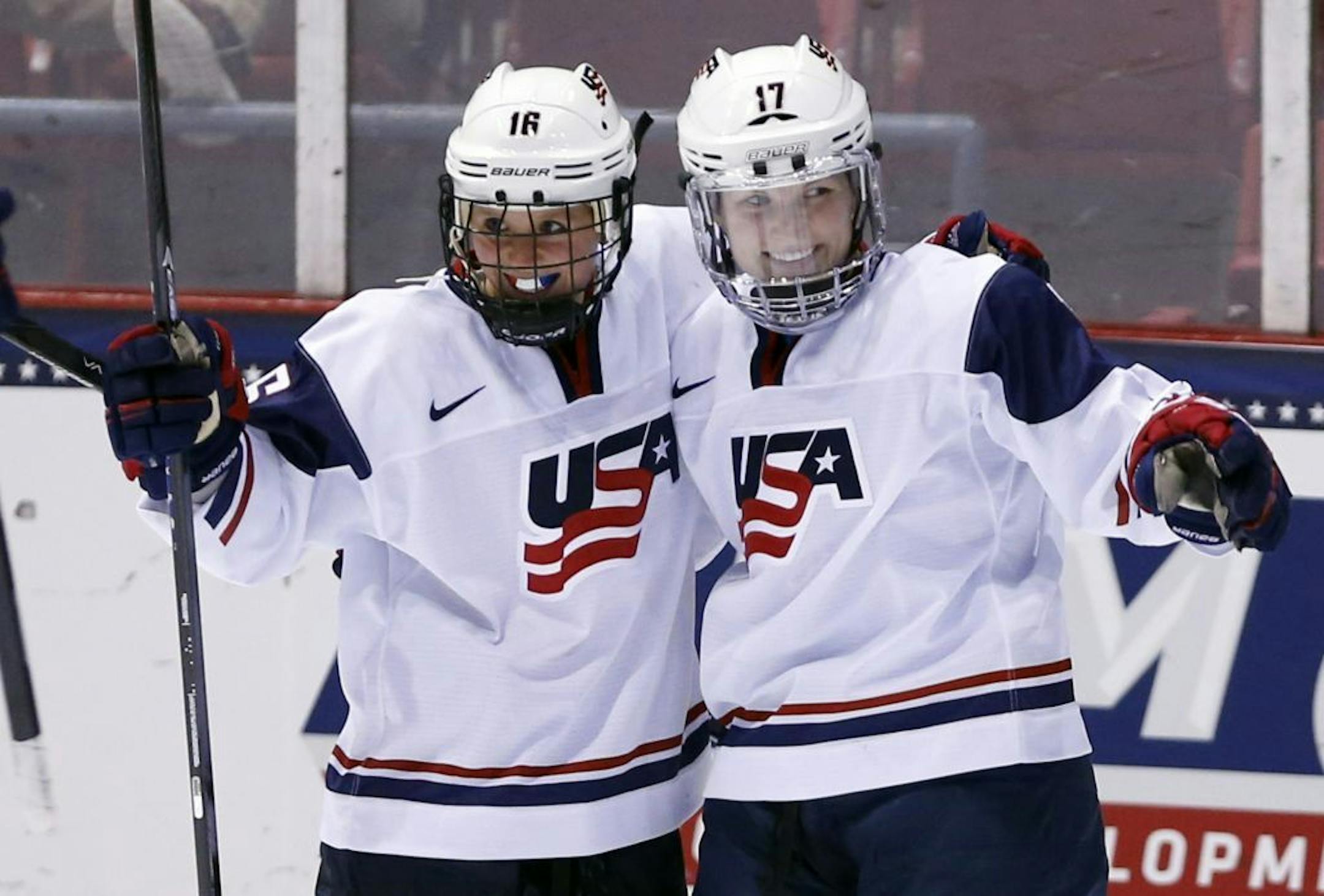 United States' Jocelyne Lamoureux (17) celebrates her goal against Sweden with teammate Kelli Stack (16) during the second period of a Four Nations Cup women's third-place hockey game on Saturday, Nov. 9, 2013, in Lake Placid, N.Y.