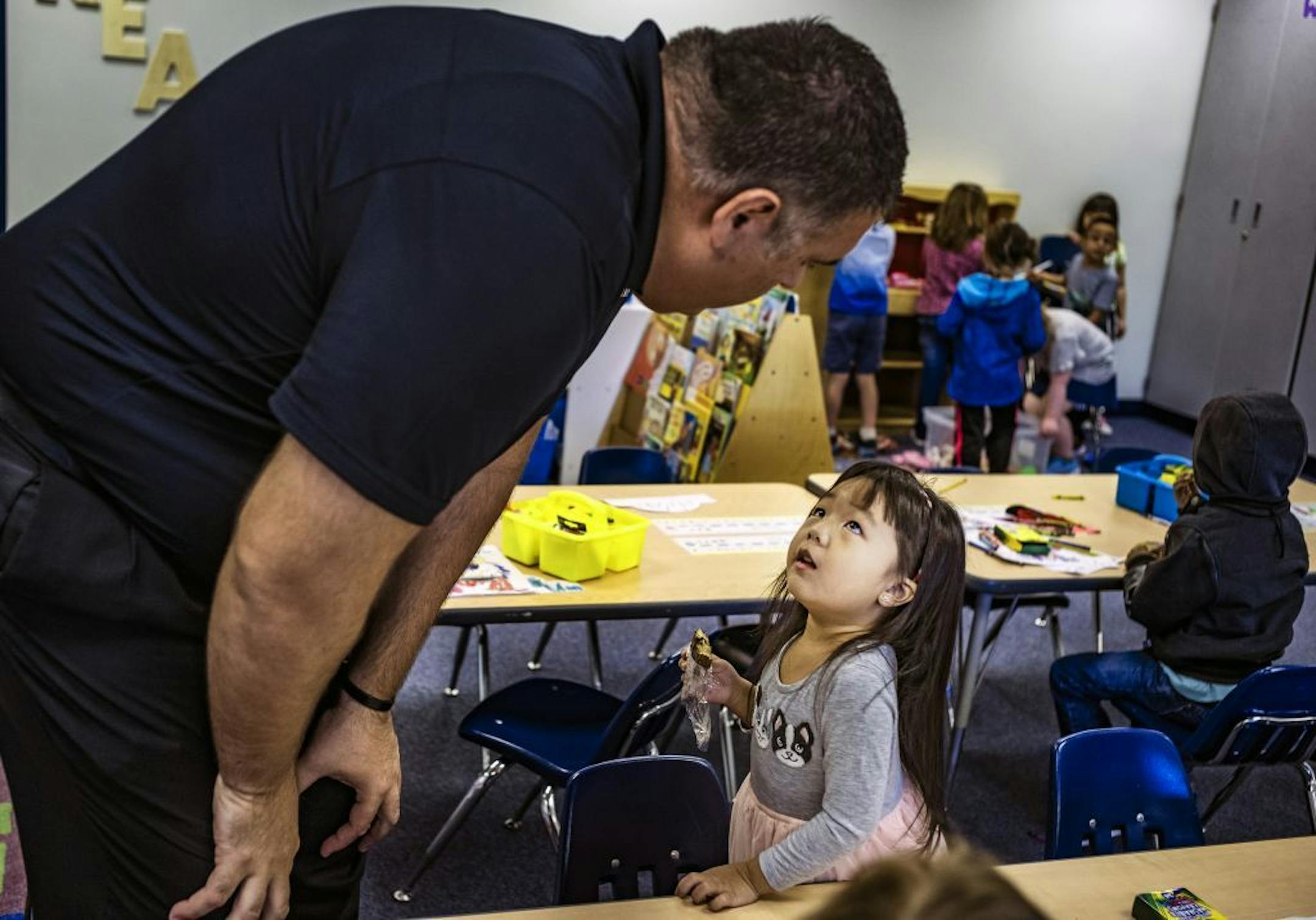 Skyview Elementary Principal Travis Barringer asked Natalie Vang what she was having for lunch in teacher Travis Fick's kindergarten class.