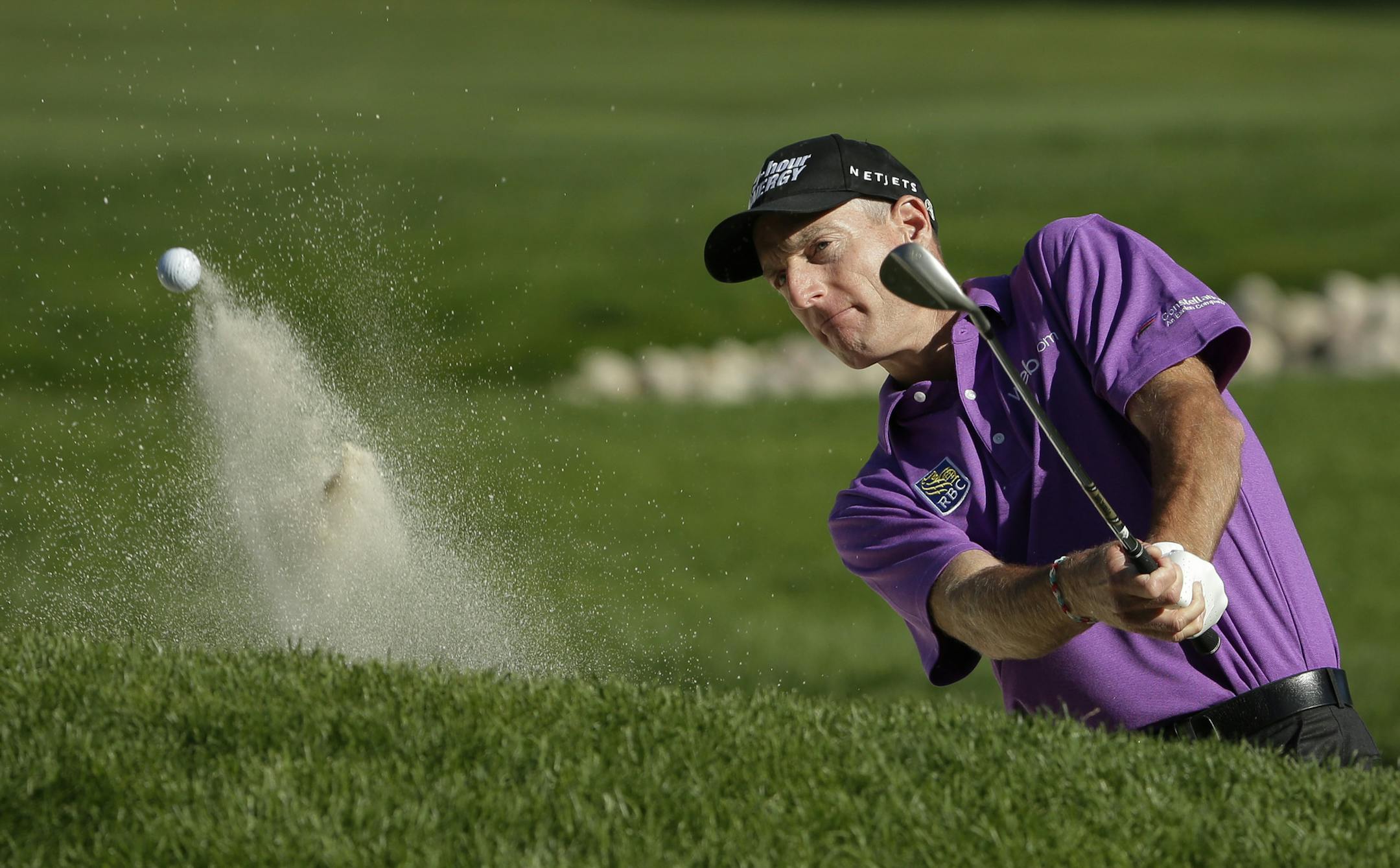 Jim Furyk hits out of a bunker on the 11th hole during the third round of the PGA Championship golf tournament at Oak Hill Country Club, Saturday, Aug. 10, 2013, in Pittsford, N.Y. (AP Photo/Charlie Riedel)