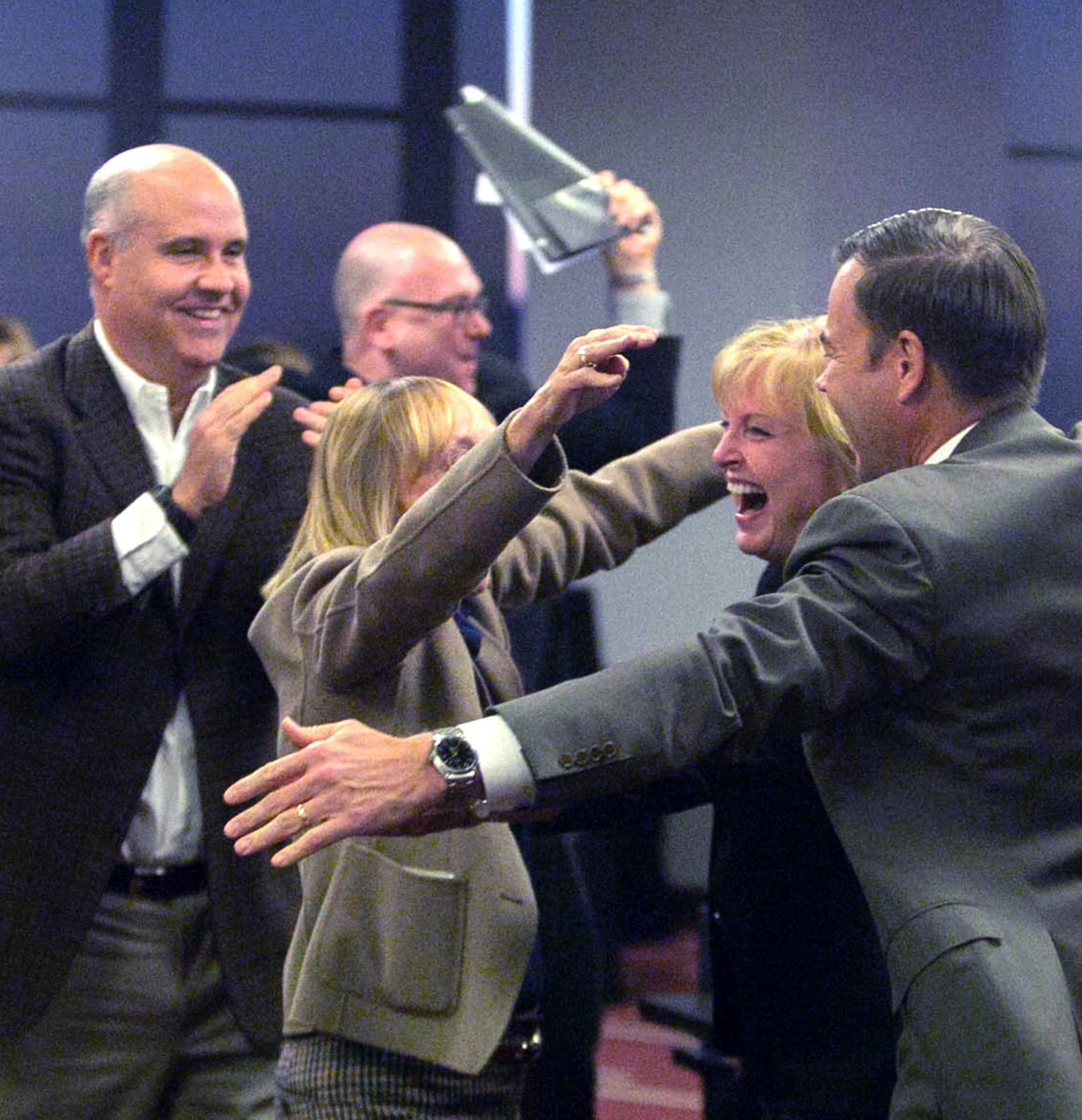 Mary Brainerd, president and CEO of HealthPartners, Inc. and Minnesota Final Four Bid Committee co-chair, in middle, is swarmed by other committee members Friday at the momnet Minneapolis was selected to hold the 2019 Final four Basketball tournamnet. other members are, David Mortenson, center, president of Mortenson Construction and Minnesota Final Four Bid Committee co-chair, far left, Norwood Teague, director of athletics at the University of Minnesota, arm covering her face is, Michele Kelm-