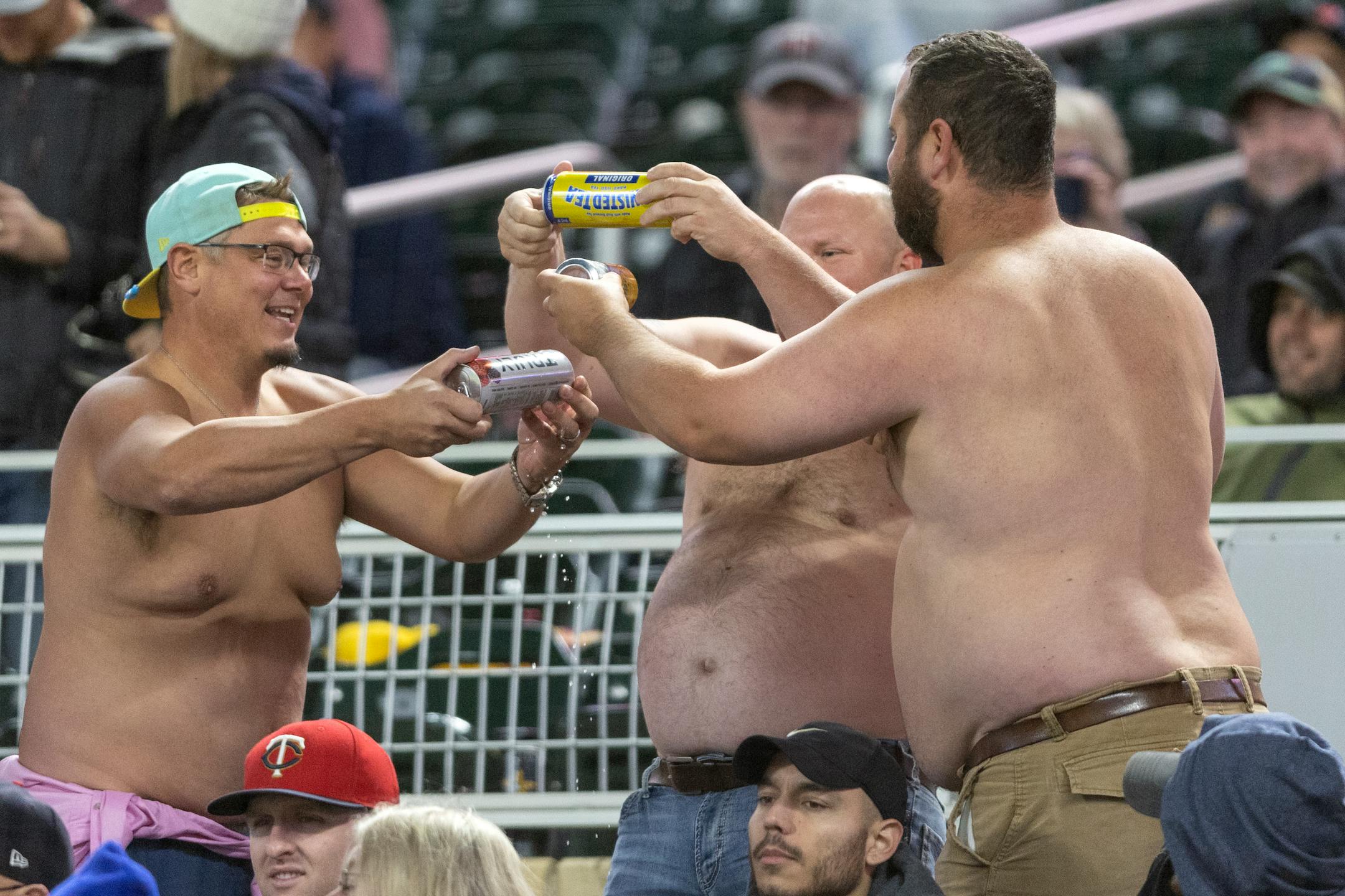 Shirtless fans drank beers in the seventh inning.