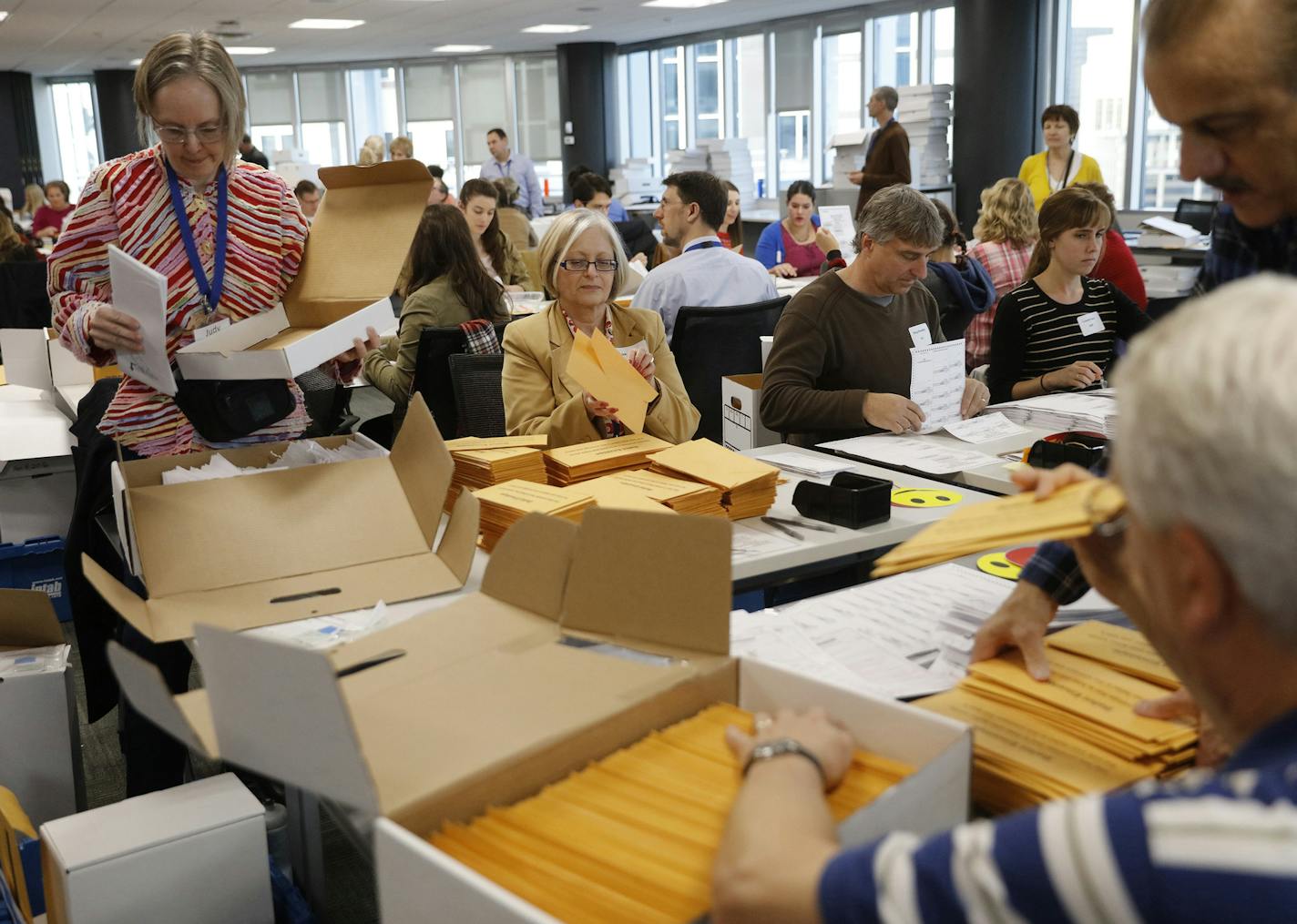 Hundreds of volunteers and election officials work on the absentee ballot count on Thursday, Nov. 3, 2016 in Minneapolis. (Tom Wallace/Minneapolis Star Tribune/TNS)