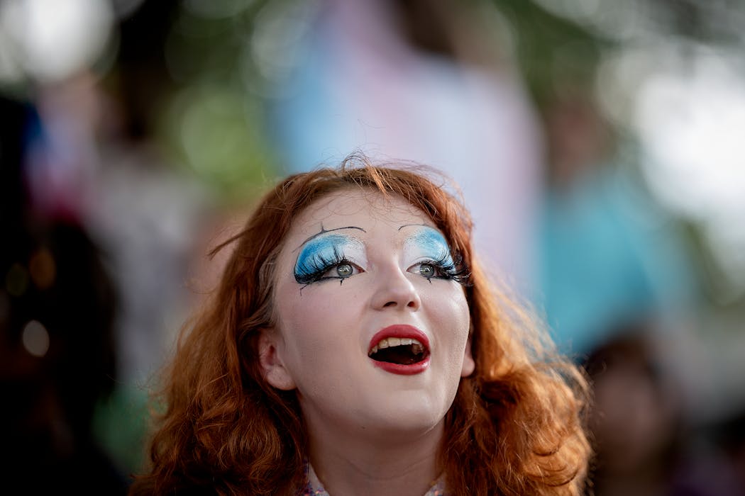 Calliope Schaan, 15, a FAIR School student, watches others dance on stage after she performed at Twin Cities Pride Youth Night at Loring Park on Friday.