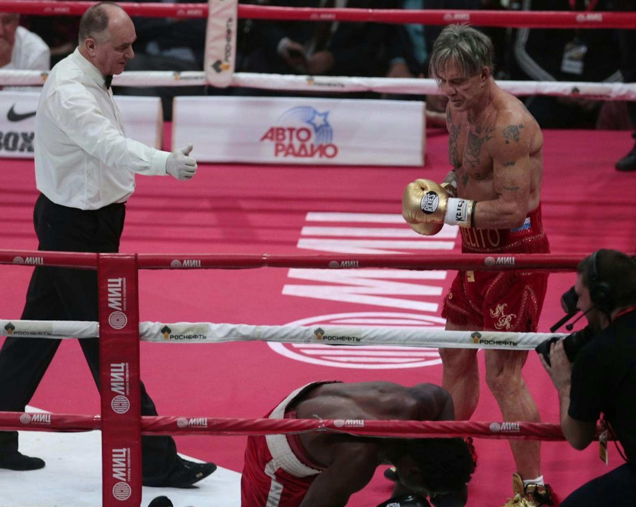 US actor Mickey Rourke, right, looks at his opponent Elliot Seymour of the United States, during their professional boxing match, at the Luzhniki Stadium, Moscow, Friday, Nov, 28, 2014. Hollywood actor Mickey Rourke returned to the boxing ring Friday at the age of 62, defeating a fighter less than half his age in an exhibition bout.