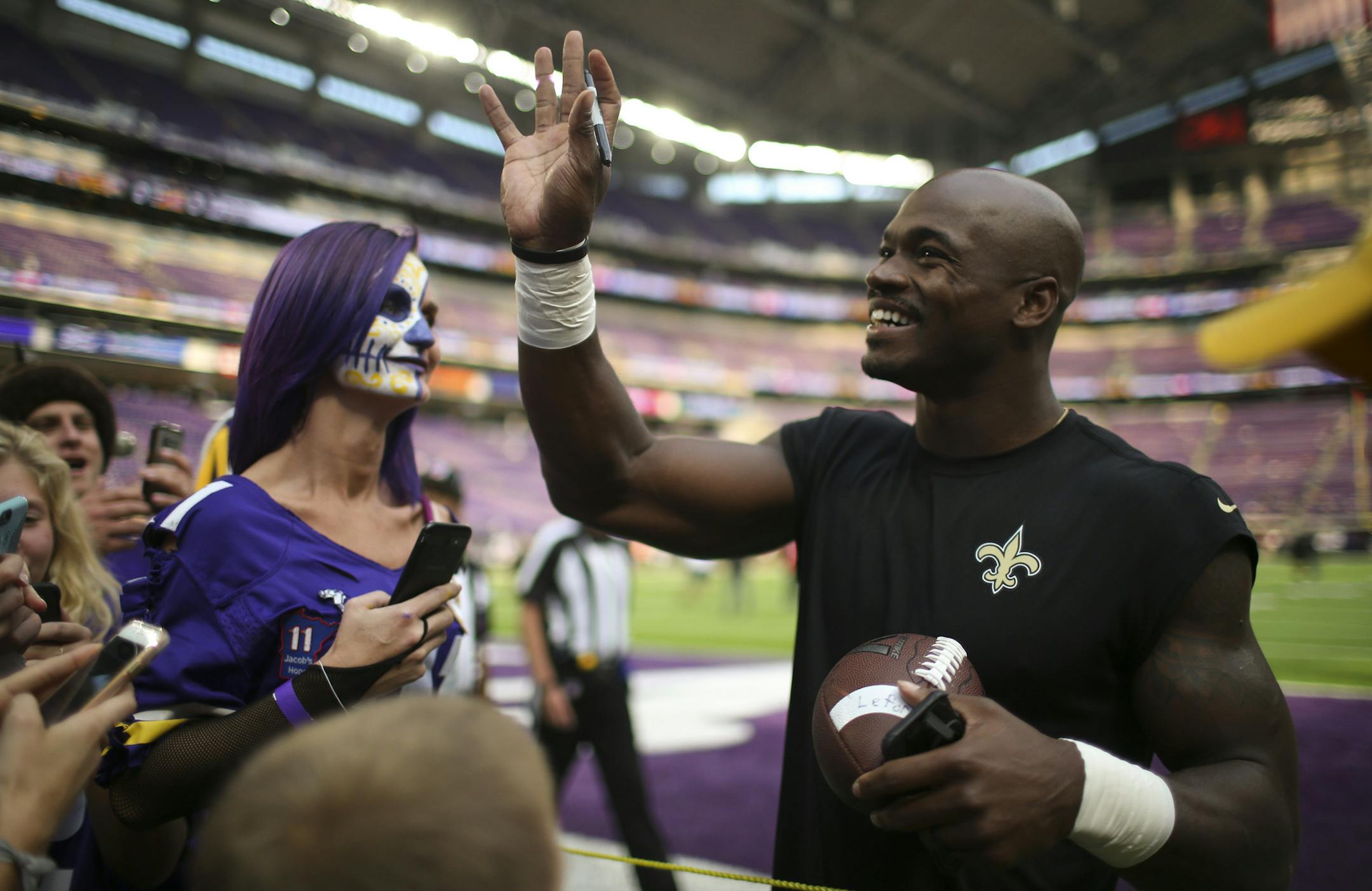 New Orleans Saints running back Adrian Peterson waved to fans in the stands while signing autographs on the sidelines during pregame warmups before Monday night's game. ] JEFF WHEELER ï jeff.wheeler@startribune.com The Minnesota Vikings faced the New Orleans Saints in their season opener NFL football game on Monday night, September 11, 2011 at U.S. Bank Stadium in Minneapolis.