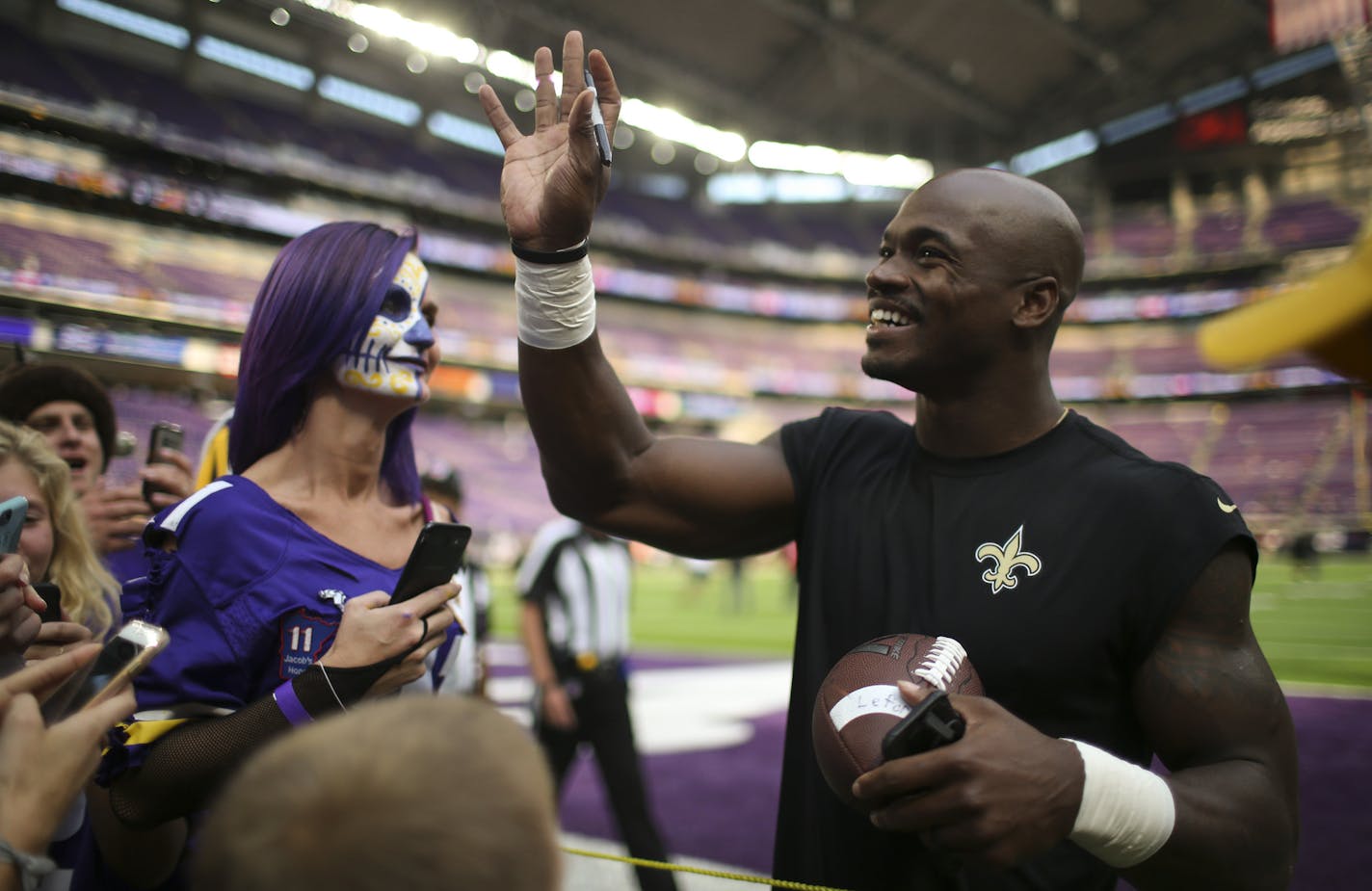 New Orleans Saints running back Adrian Peterson waved to fans in the stands while signing autographs on the sidelines during pregame warmups before Monday night's game. ] JEFF WHEELER &#xef; jeff.wheeler@startribune.com The Minnesota Vikings faced the New Orleans Saints in their season opener NFL football game on Monday night, September 11, 2011 at U.S. Bank Stadium in Minneapolis.