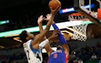 Minnesota Timberwolves forward Andrew Wiggins (22) shoots the ball over Detroit Pistons center Andre Drummond (0) in the first half of an NBA basketba