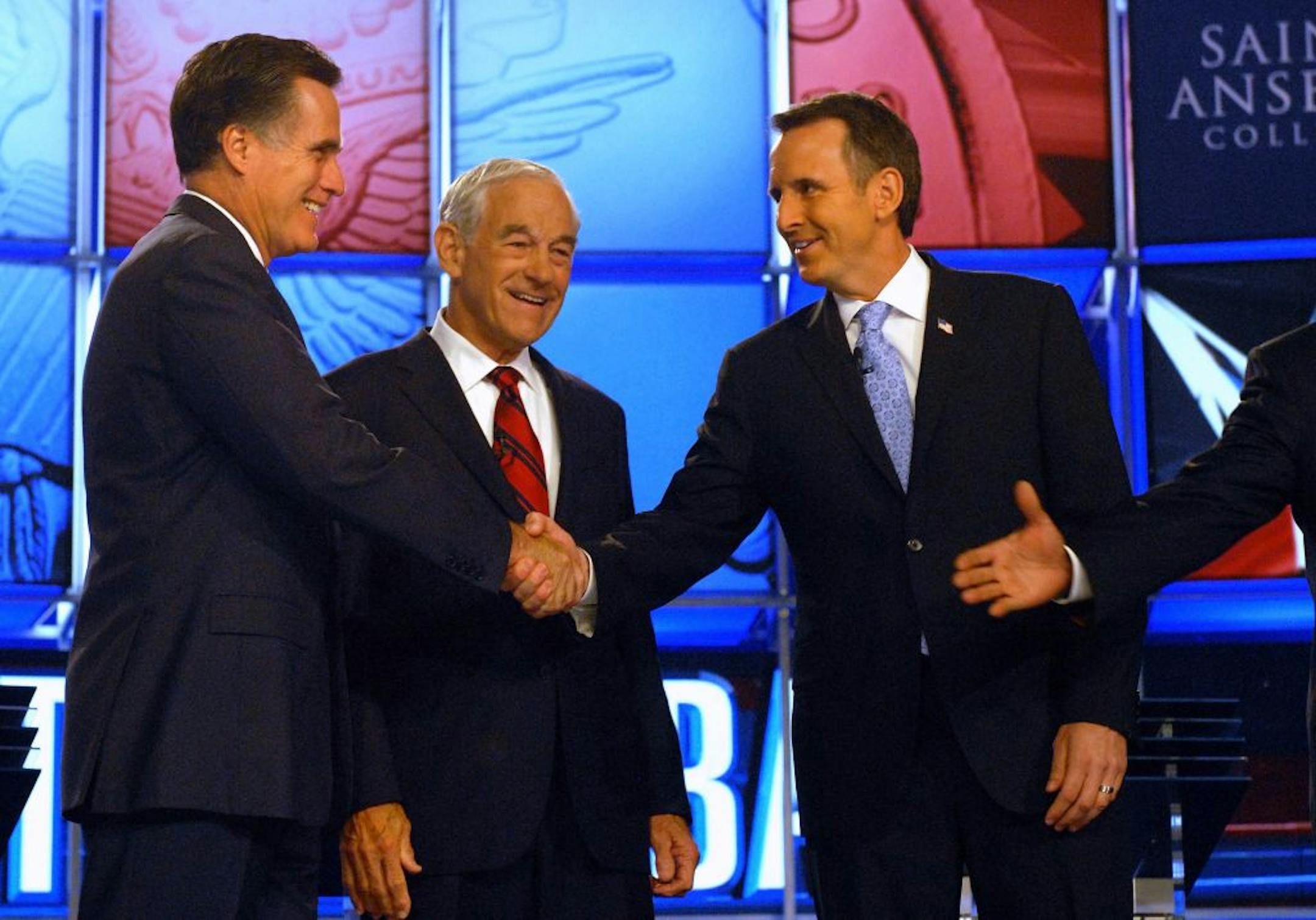 MANCHESTER, NEW HAMPSHIRE- JUNE 13: Republican candidates (L to R) former Governor Mitt Romney (MA), shakes hands with former Governor Tim Pawlenty (MN), while U.S. Rep. Ron Paul (TX) (C) looks on prior to their debate June 13, 2011 at Saint Anselm College in Manchester, New Hampshire. This is the first debate for the GOP contenders in the "First in the Nation" primary state of New Hampshire.