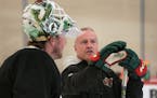 Dean Evason talked with goalie Devan Dubnyk as the Wild officially reconvened Monday at Tria Rink in St. Paul for training camp after a 123-day lag in