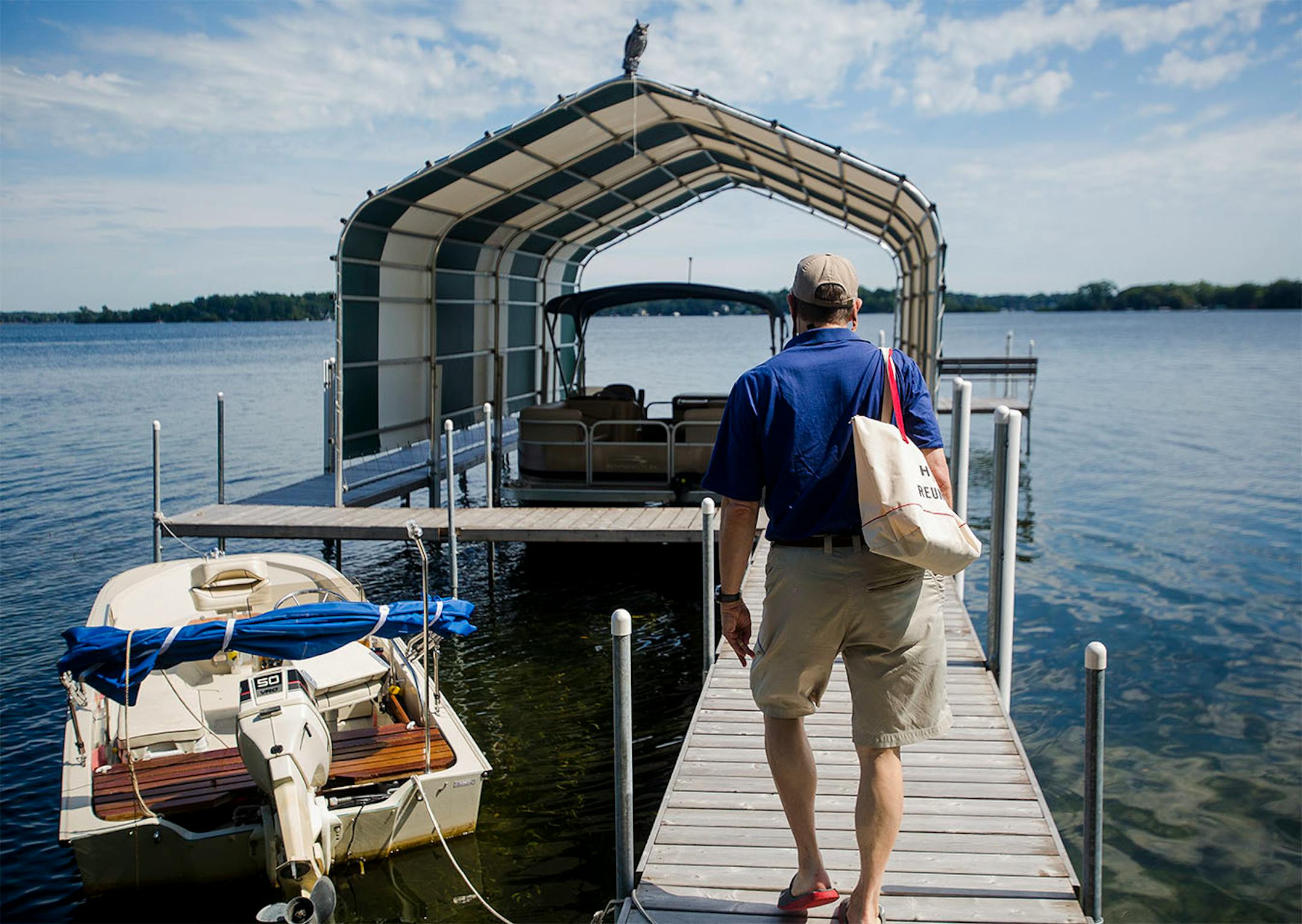 Homeowner David Moore docks his boat in front of the Crane Island cottage. It's only a short boat ride to the mainland.